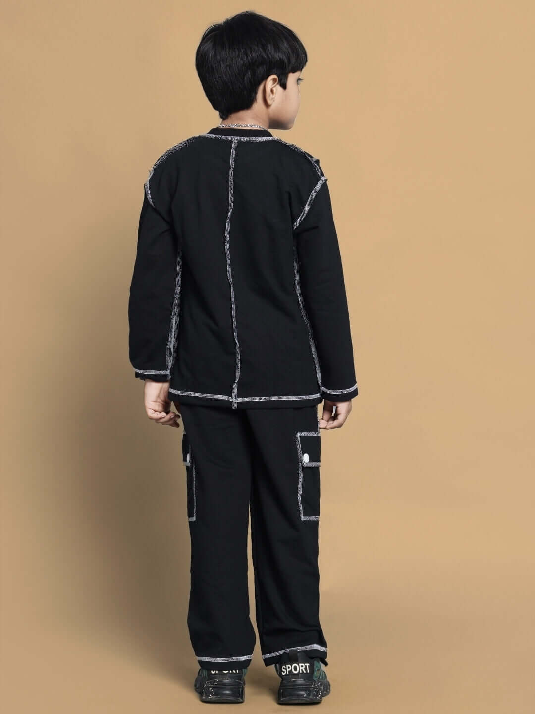 Unisex black oversized co-ord set for kids, featuring relaxed fit joggers and a long-sleeve top, made from premium cotton.