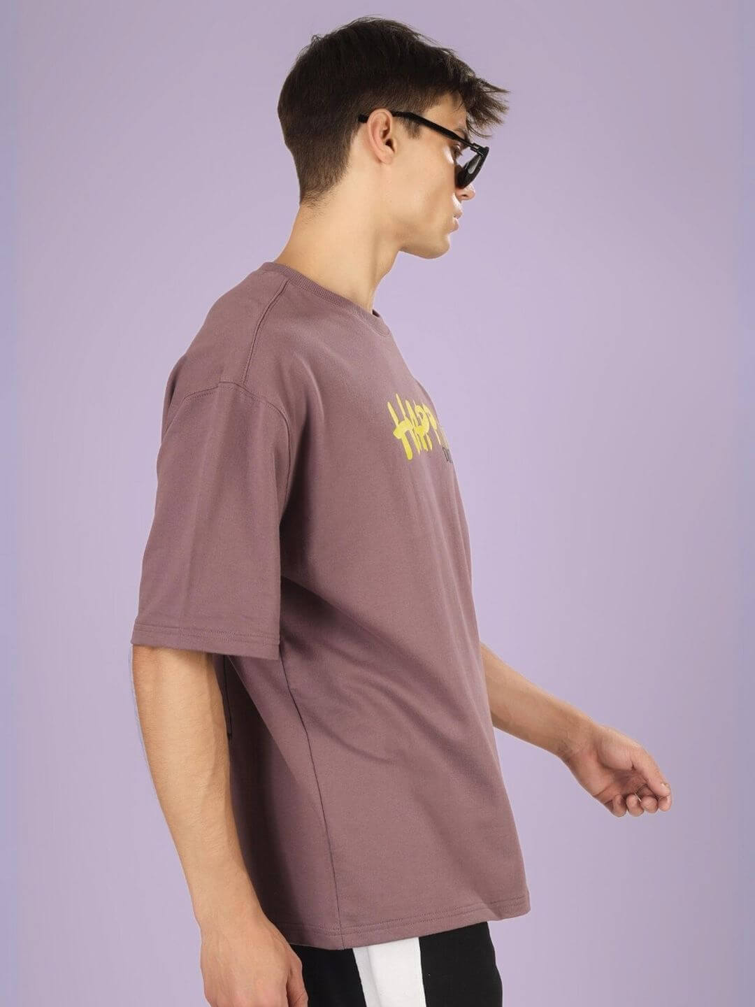 Model wearing HAPPY DUDS OVER-SIZED T-SHIRT CHINESE VOILET made from premium cotton French terry with elastane on a pastel background.