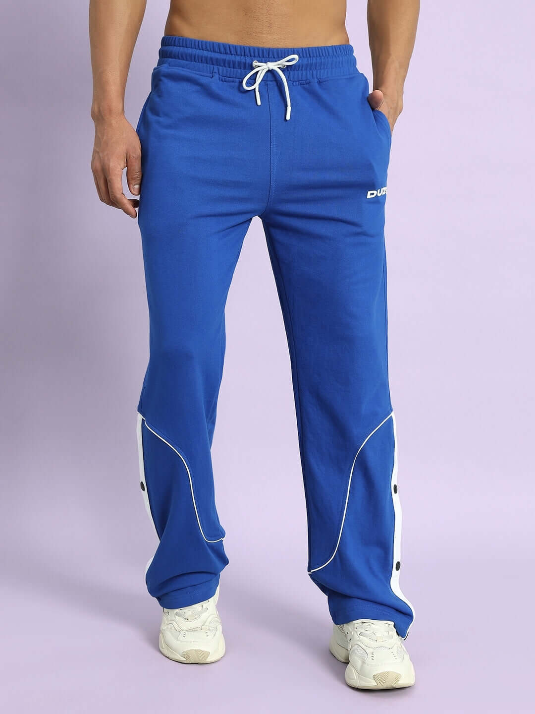 Royal blue joggers with contrast detailing, designed by DUDS and worn by a model. Ideal for custom fit options.