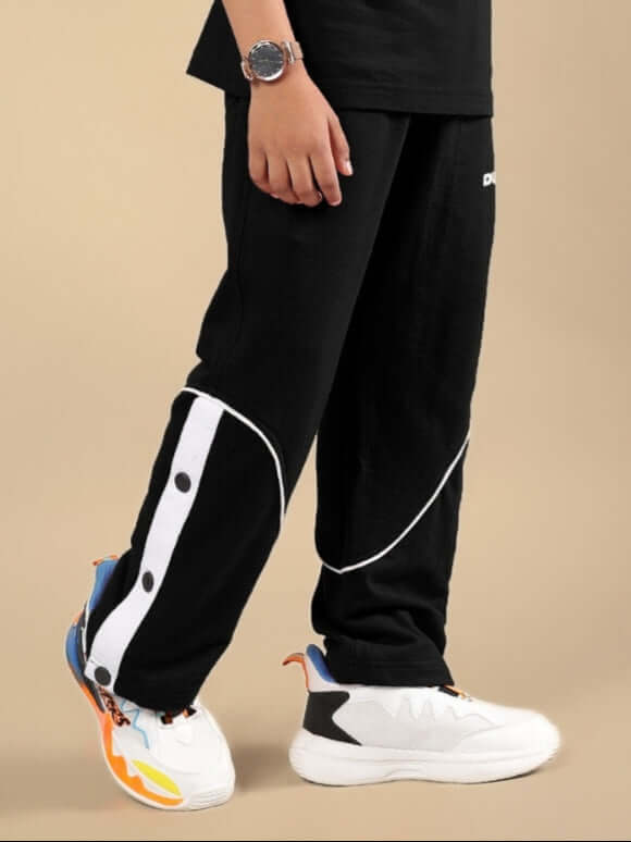Child wearing EDDIE JOGGER FOR BOYS & GIRLS BLACK with white sneakers, tailored by DUDS.