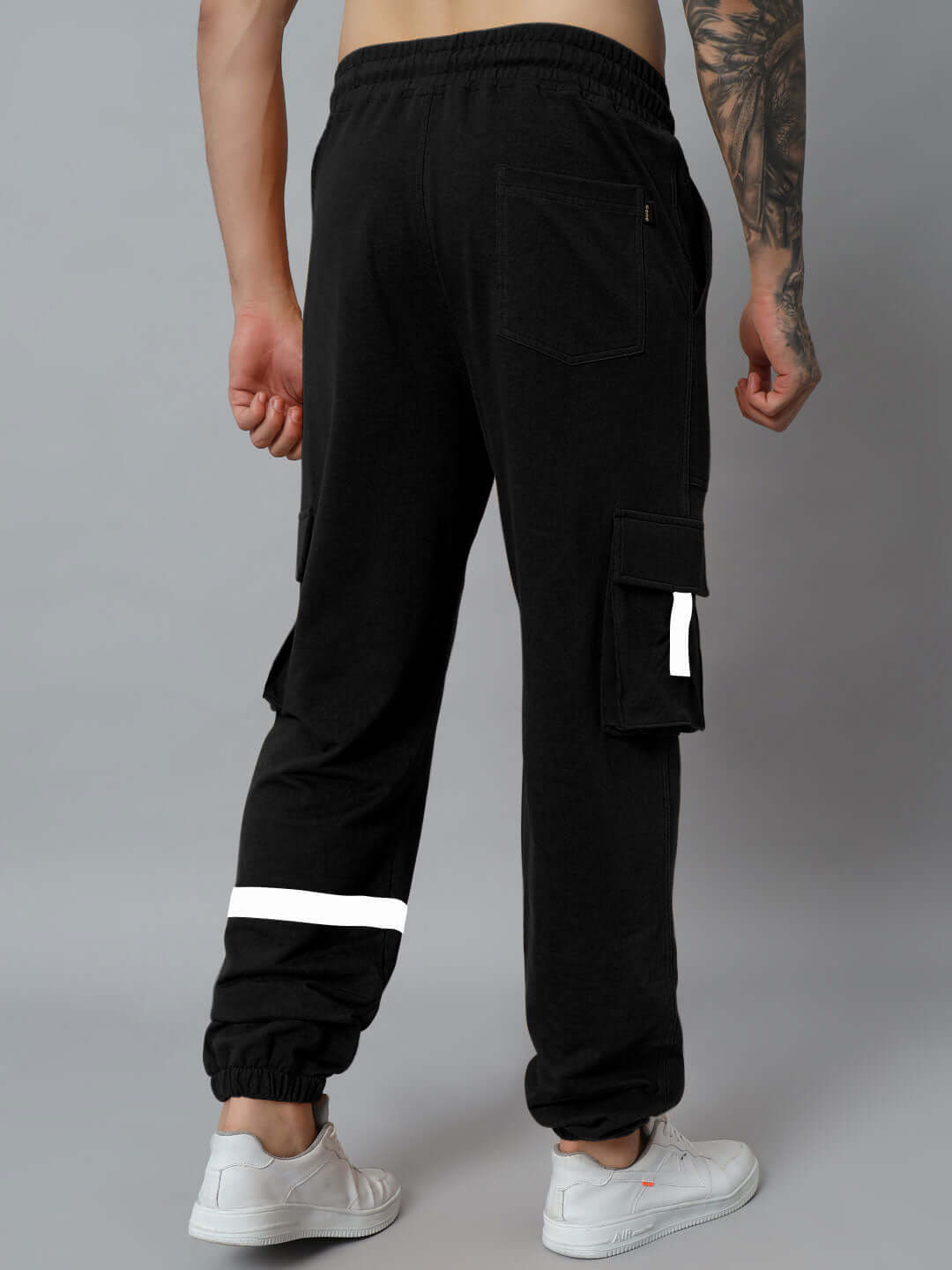 Back view of EDIFICE Relaxed Fit Cargo Pant in black, showcasing cargo pockets and reflective bands. Ideal for custom-fit tailoring options.