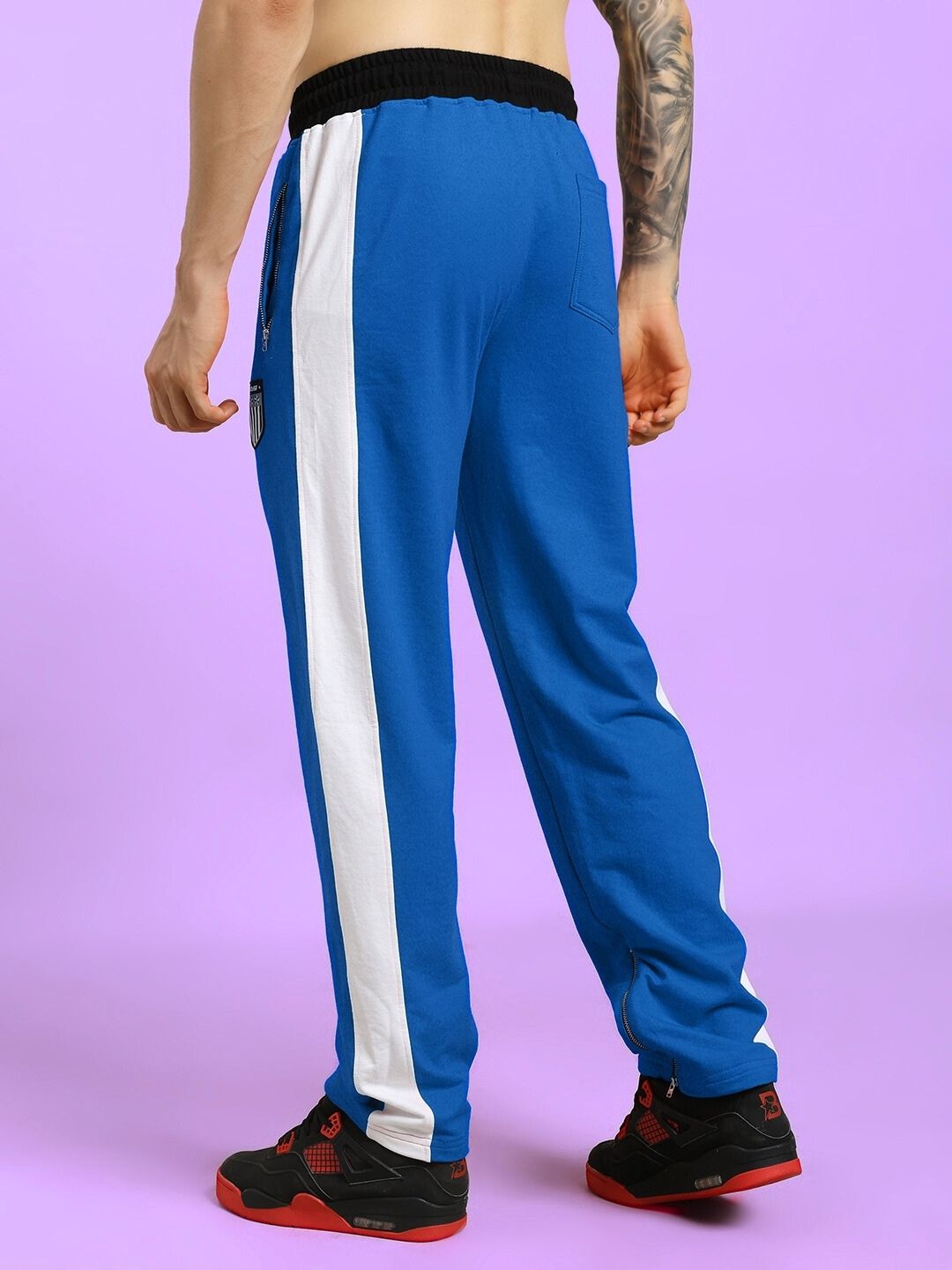 Back view of ELEGANT RELAXED-FIT JOGGERS BLUE showcasing side stripe design and comfortable fit.