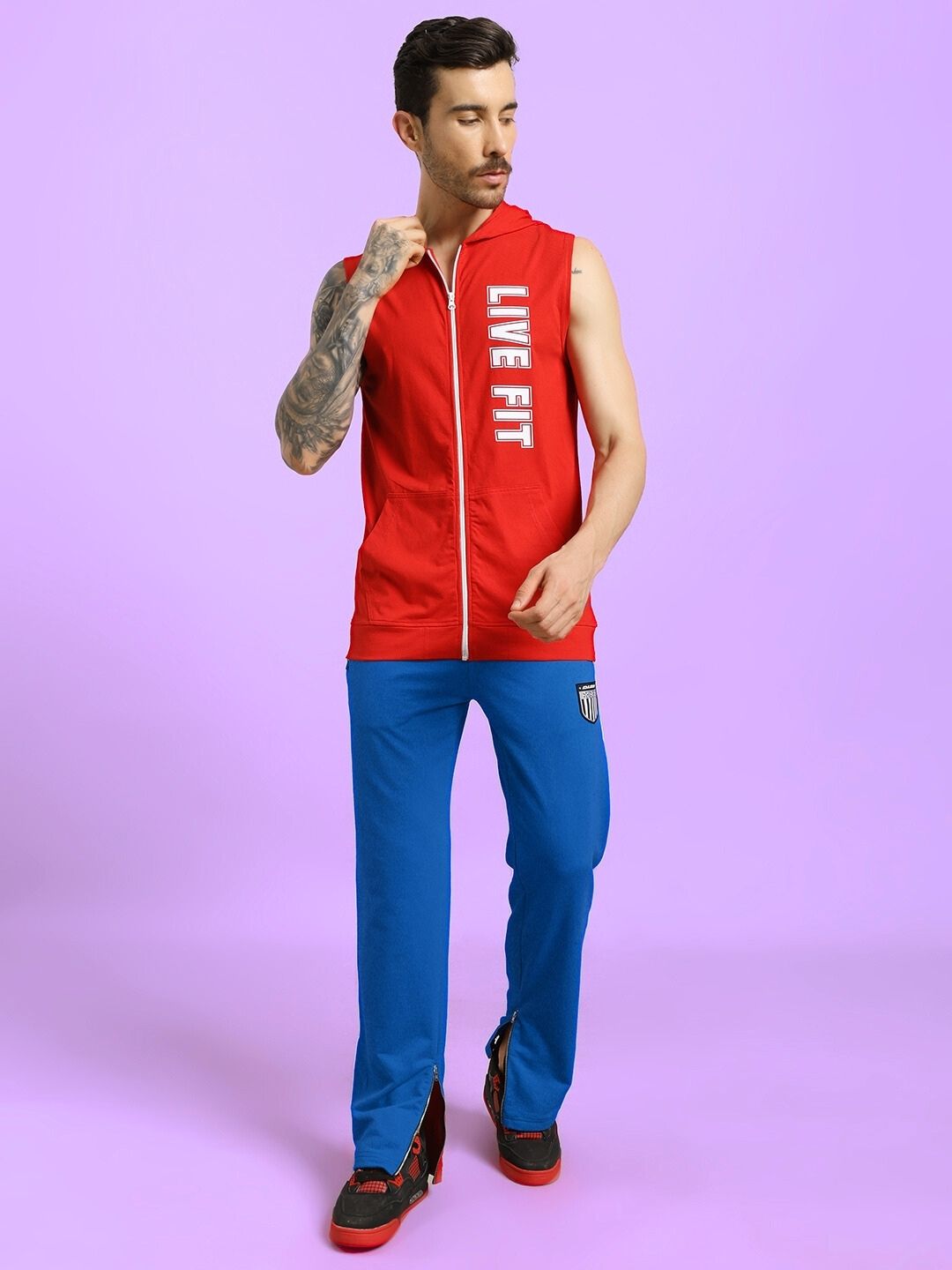 Man wearing ELEGANT RELAXED-FIT JOGGERS BLUE against a purple background