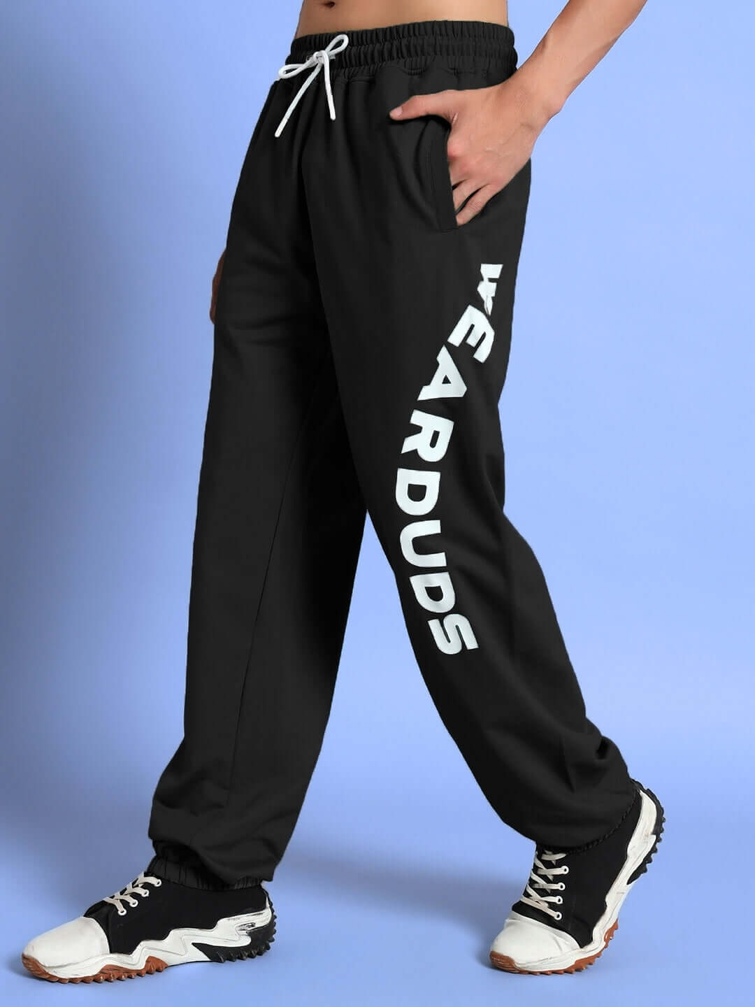 Man wearing Ellen Relaxed Fit Jogger in black with 'WEAR DUDS' branding, showcasing side view of comfortable fit and design.