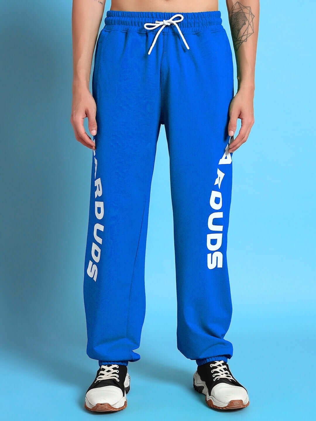 "ELLEN Relaxed Fit Jogger in Blue with custom fit option, made by DUDS experienced tailors, shown with white drawstring and sneakers."