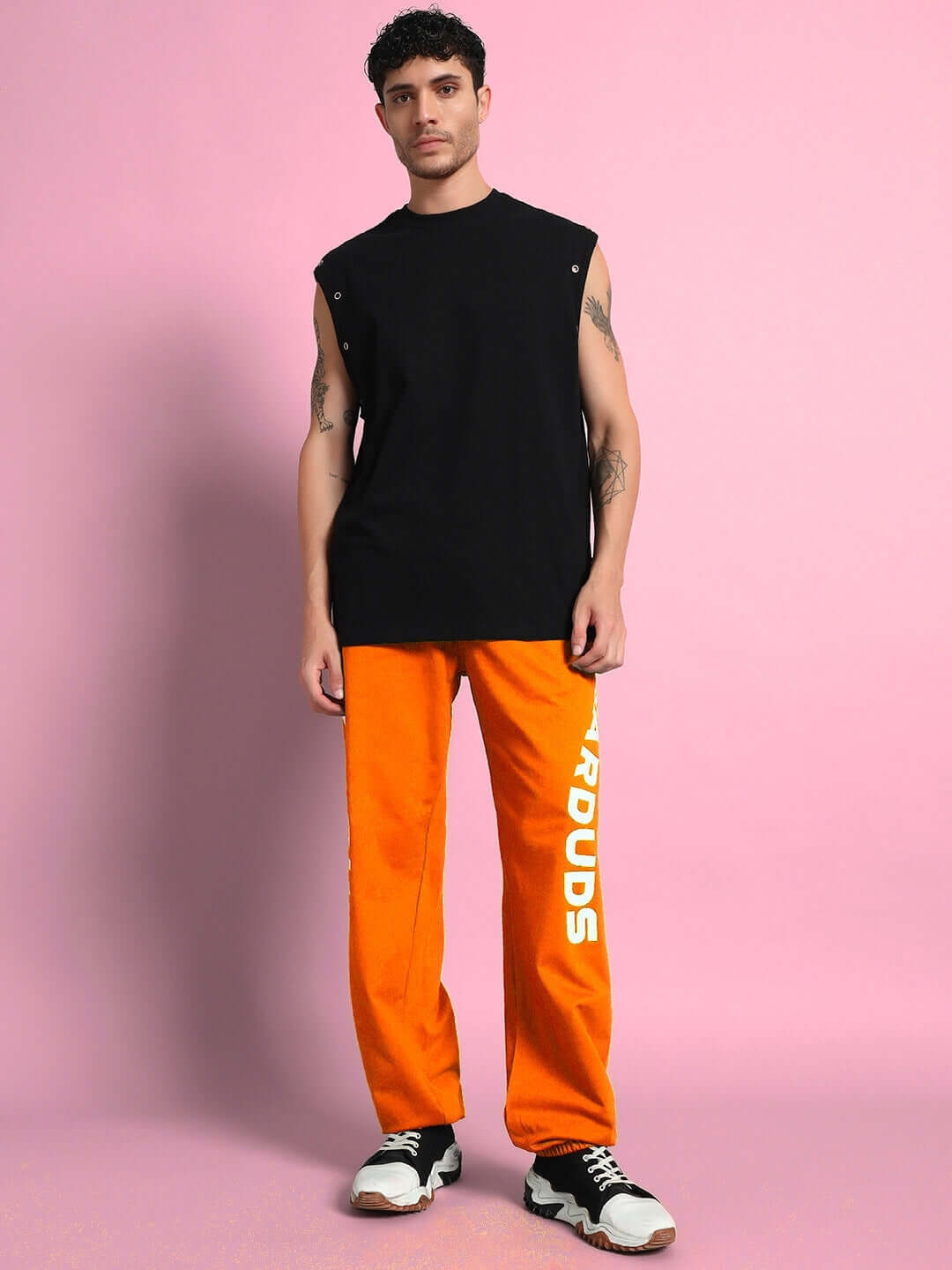 Man wearing ELLEN RELAXED FIT JOGGER ORANGE, casual streetwear style with vibrant orange color, perfect for workouts and everyday wear.
