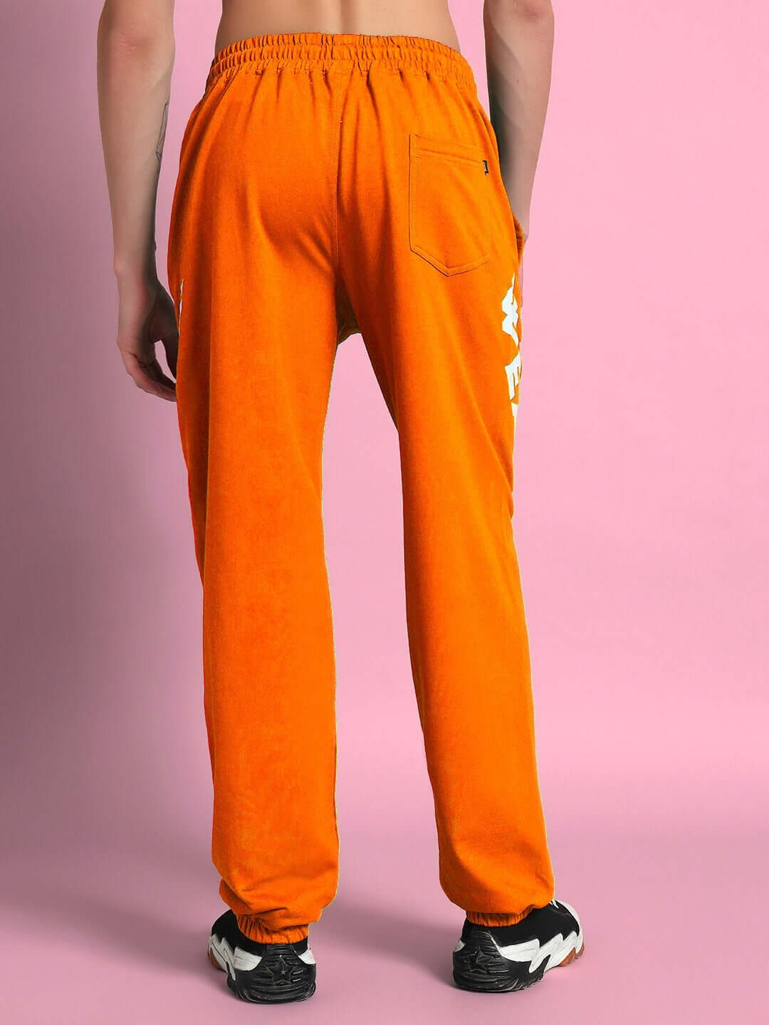 Back view of person wearing ELLEN RELAXED FIT JOGGER ORANGE, showcasing bright color and comfortable design, ideal for casual wear.