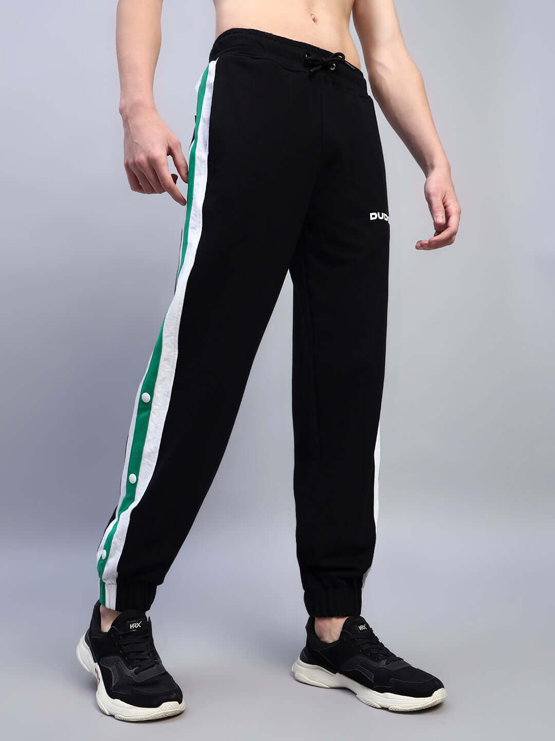 Black Emirati Stripes Joggers with green stripe, worn by model, premium tailored activewear, customizable size available from DUDS