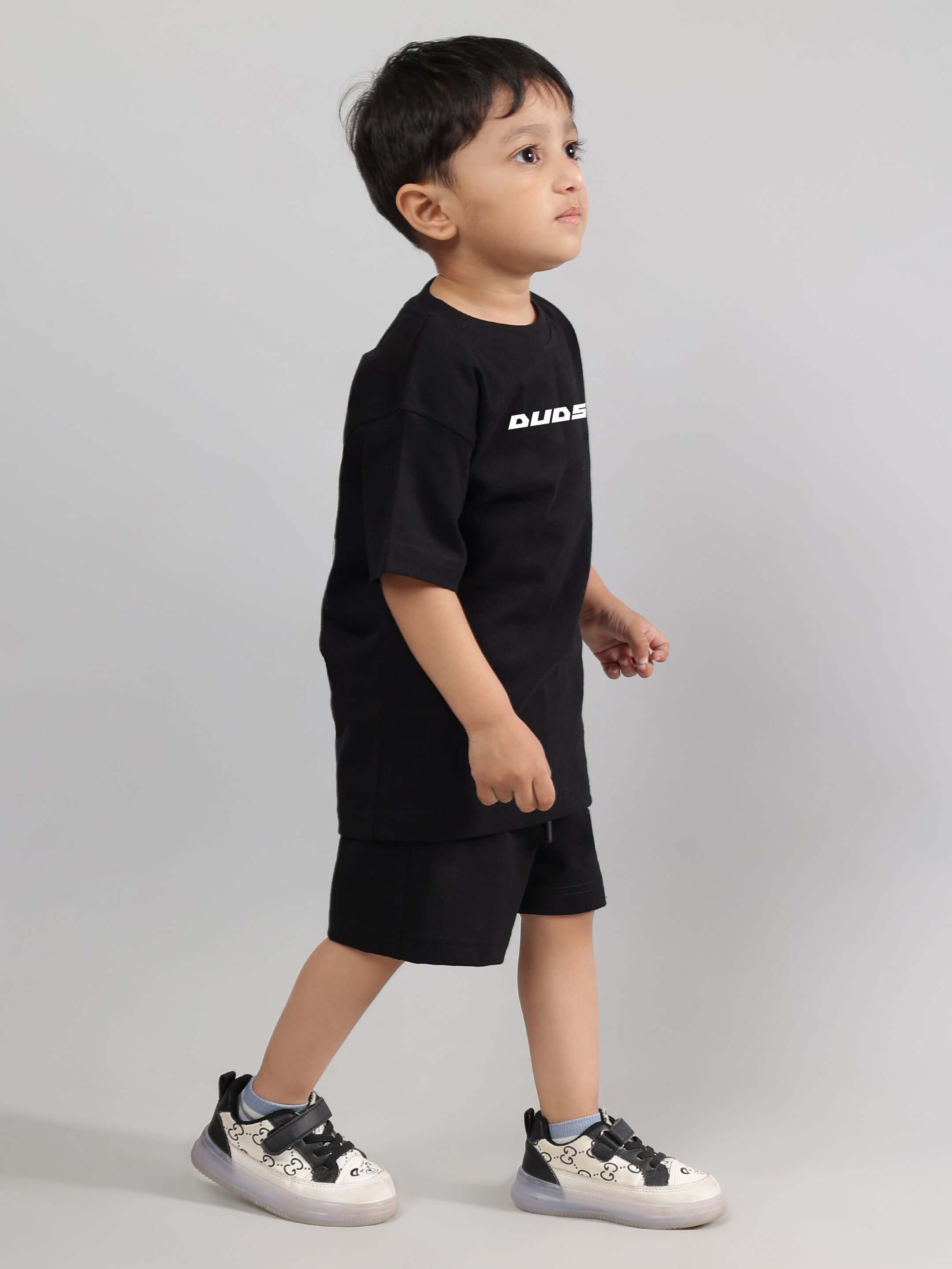Child wearing ENJOY THE WIND CO-ORD FOR BOYS GIRLS BLACK, showcasing a trendy unisex outfit.