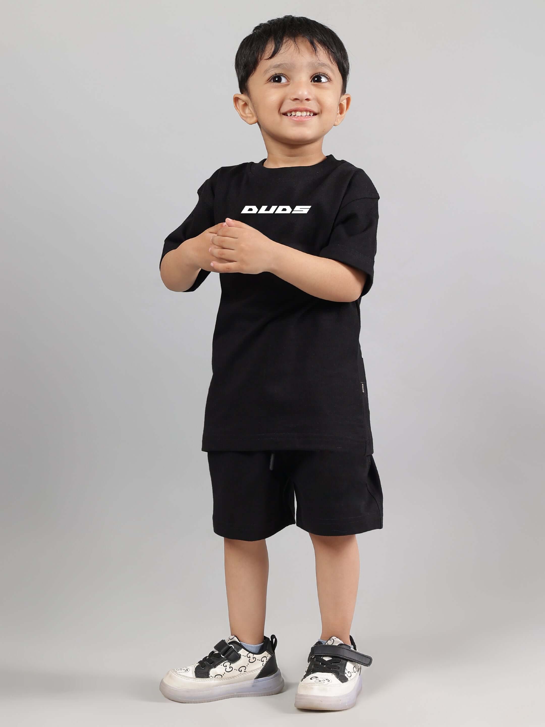 Boy wearing ENJOY THE WIND CO-ORD FOR BOYS GIRLS BLACK, a trendy and comfortable kids' outfit for school and play.