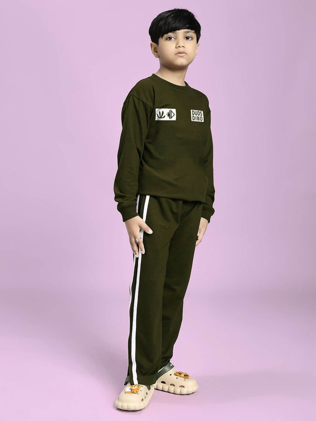 Child wearing EPIC DINO CO-ORD FOR BOYS GIRLS OLIVE GREEN with stylish dinosaur-themed design and matching top and bottom set.