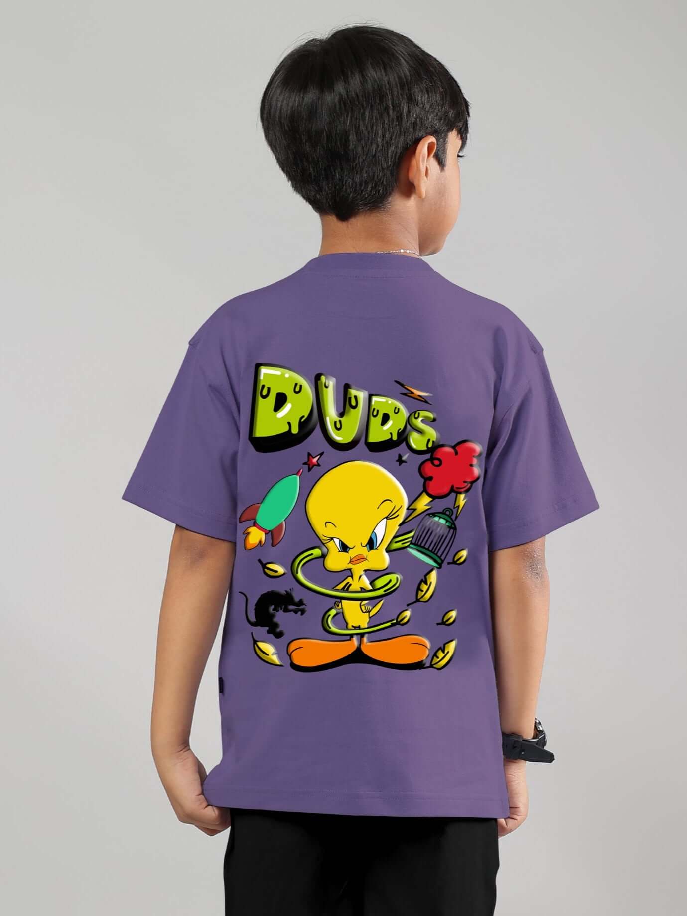 Child wearing ESCAPED TWEETY T-shirt in wisteria purple, featuring vibrant cartoon print on the back.