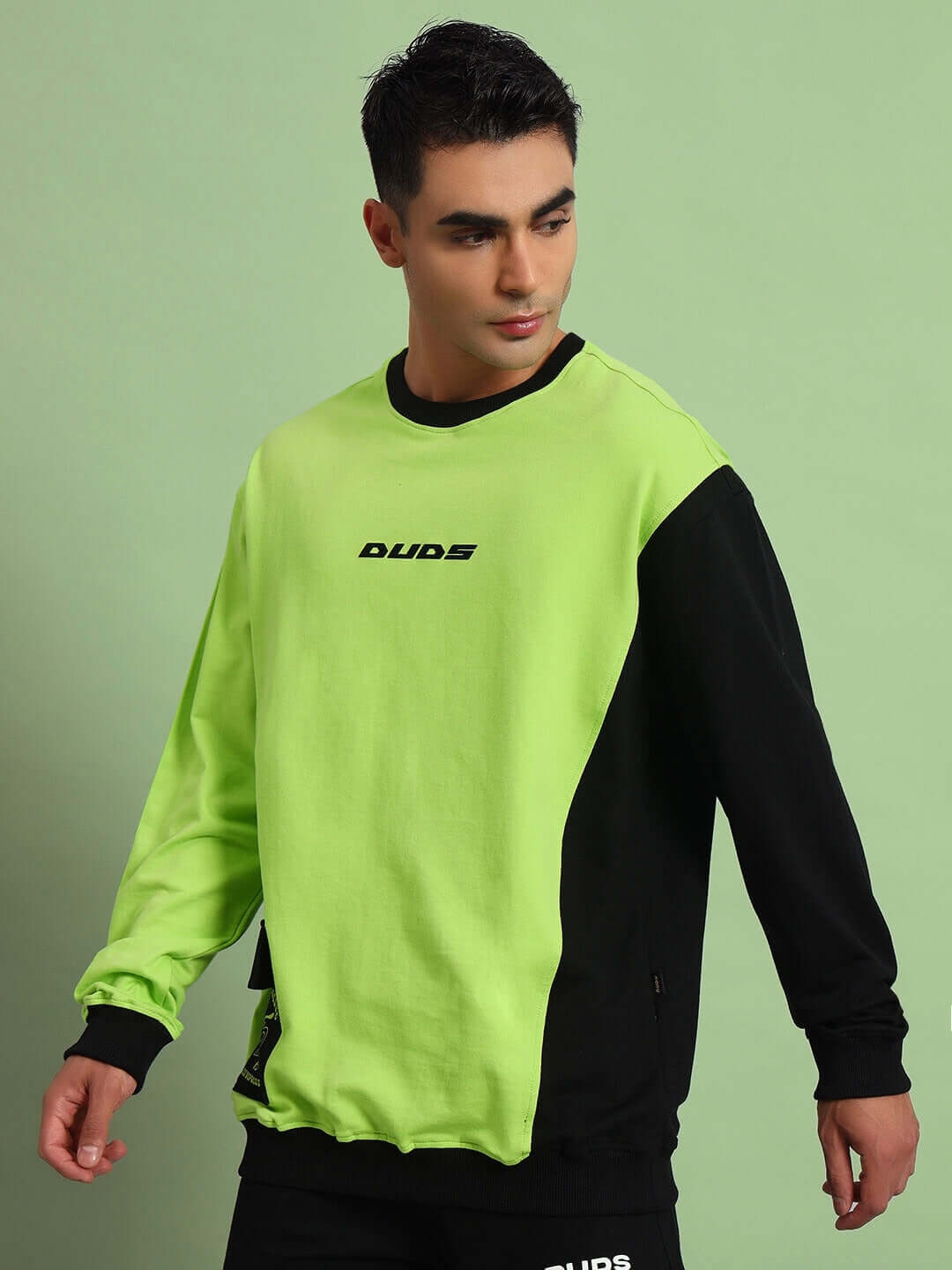 Man wearing an Espresso oversized neon green and black sweatshirt, showcasing premium heavy gauge fabric, styled in modern casual fashion.