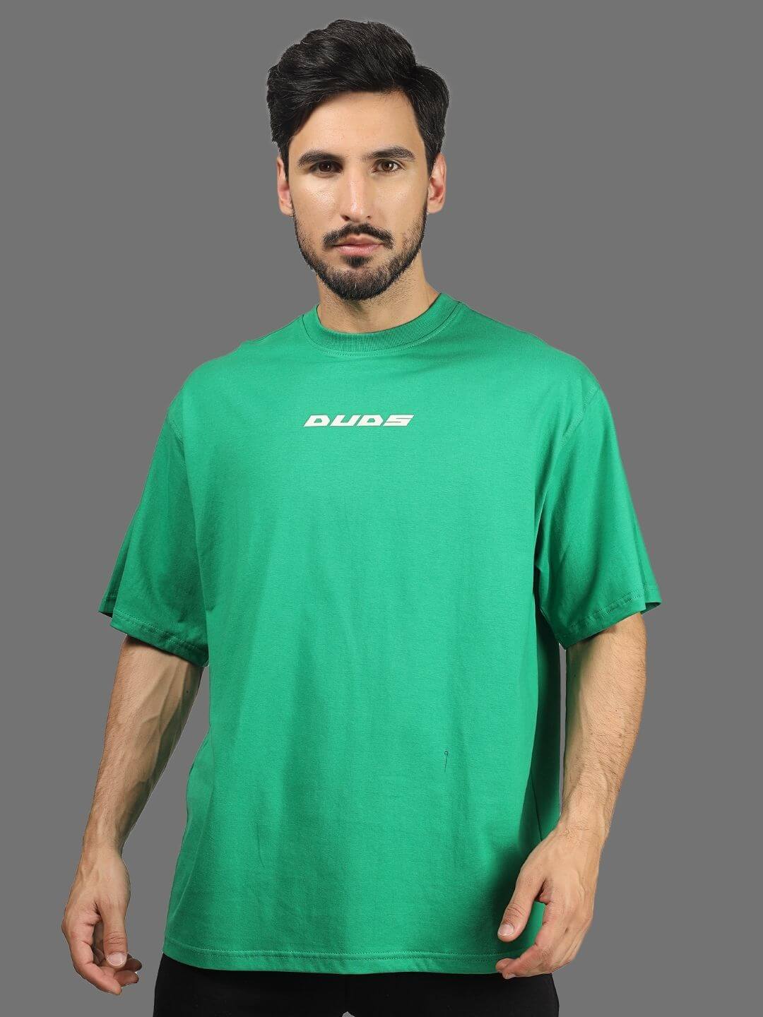 Model wearing ETCETERA oversized green t-shirt by DUDS, available with custom fit option for personalized sizing.