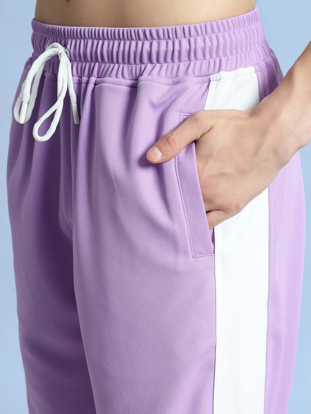 Lavender joggers with white side stripe, featuring an elastic waistband and a hand in pocket, by DUDS.