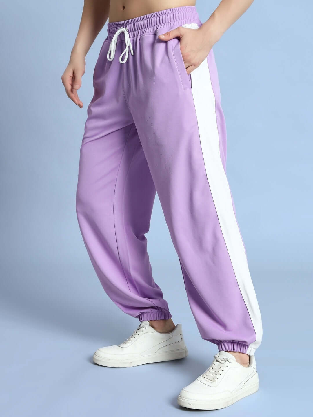 EUPHORIA JOGGERS in lavender-white, featuring a relaxed fit and elastic waistband, modeled against a soft blue background.