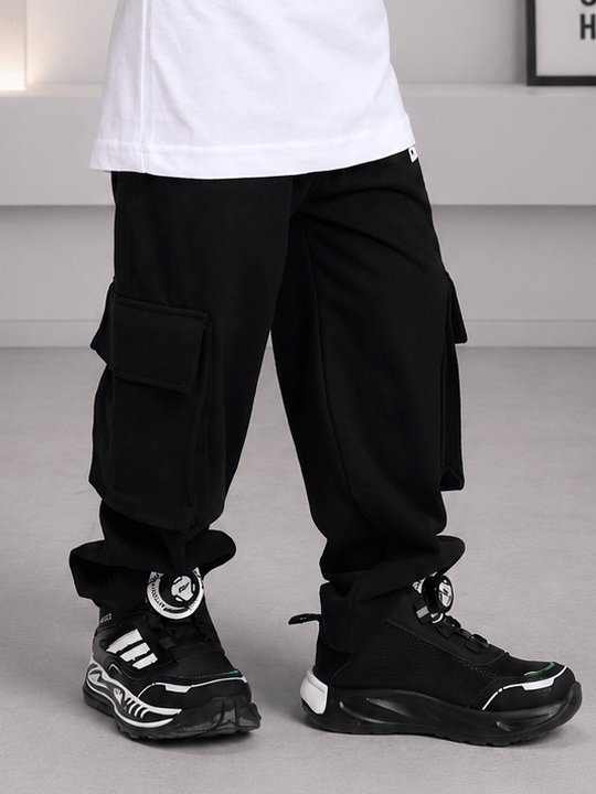 EVERYDAY ADVENTURE JOGGER FOR BOYS GIRLS BLACK seen with trendy sneakers, perfect for casual outings and adventures.