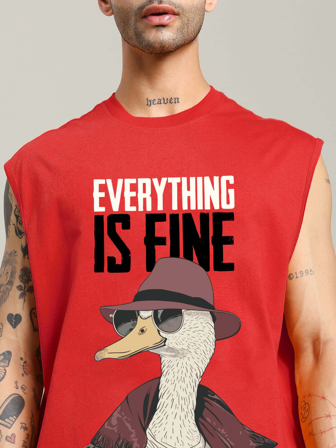 Model wearing EVERYTHING FINE GYM T-SHIRT RED with a duck graphic and "Everything is Fine" text, ideal for stylish workouts.