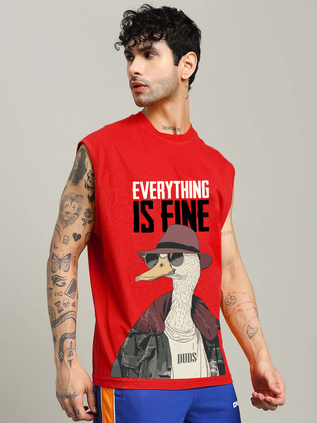 Man wearing EVERYTHING FINE GYM T-SHIRT RED with cartoon graphic, showcasing breathable and moisture-wicking features for workouts.