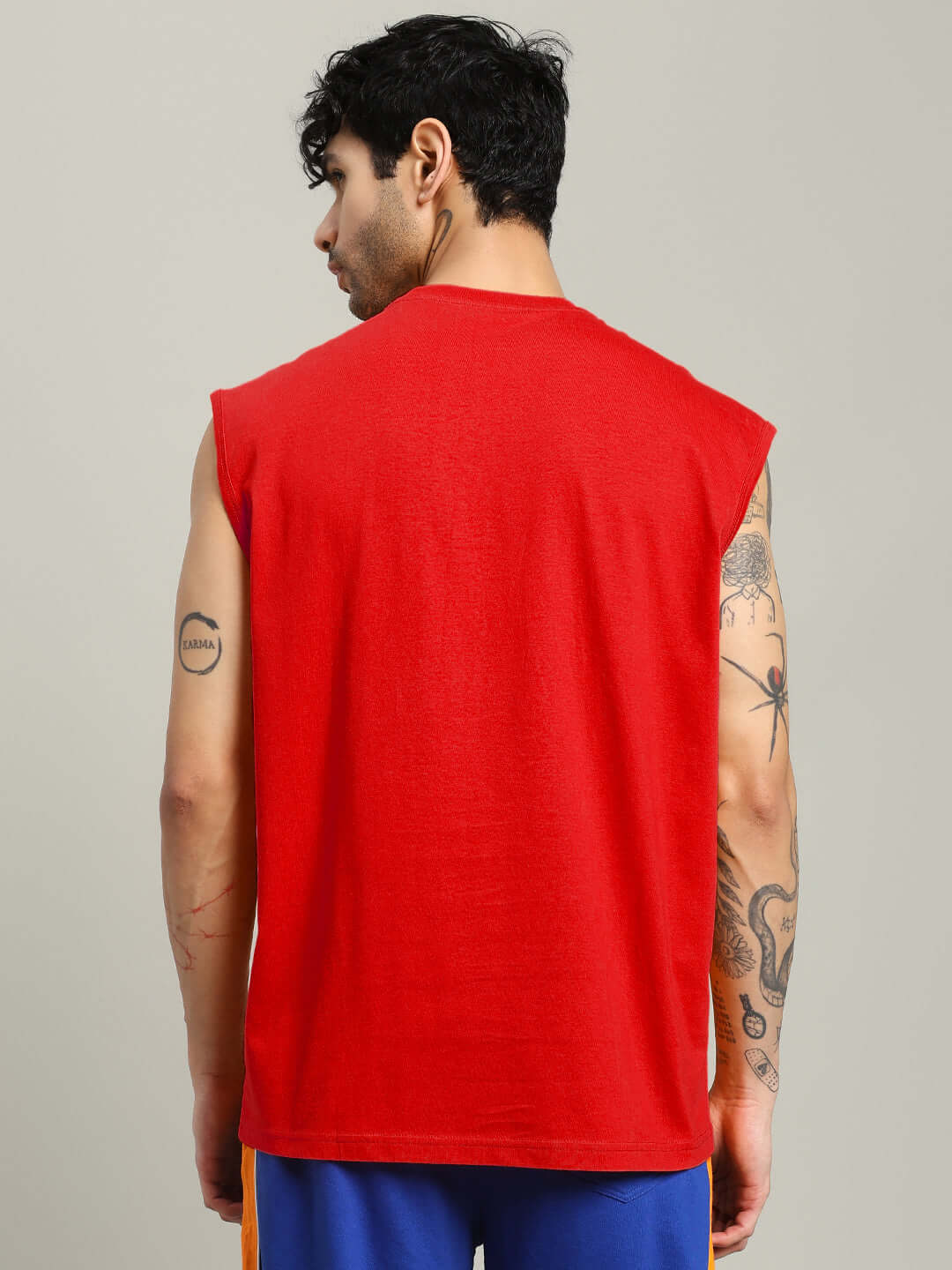 Back view of model wearing EVERYTHING FINE GYM T-SHIRT RED, showcasing breathable fabric for comfortable workouts.