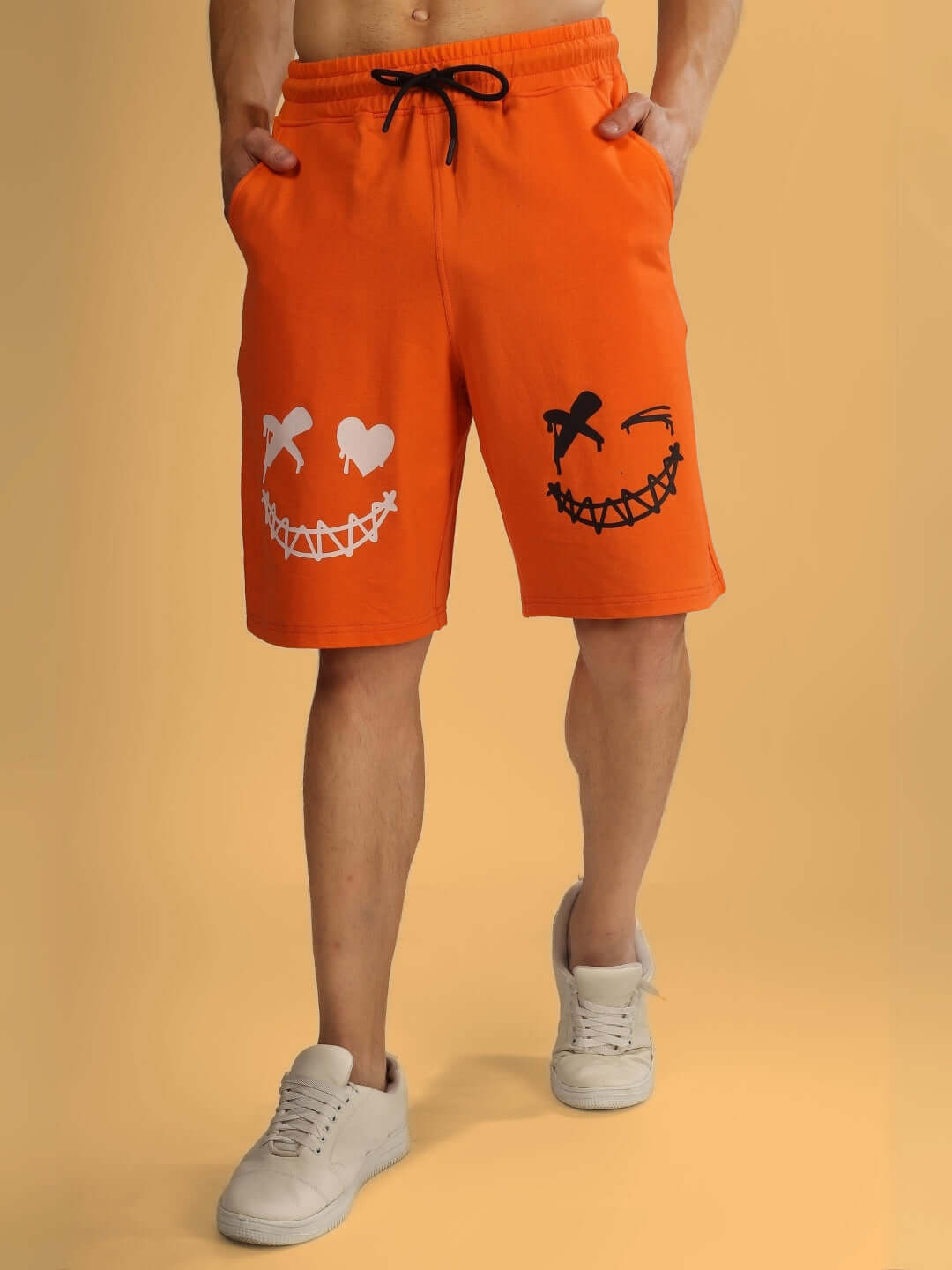 EVIL SMILE Regular Fit Orange Shorts featuring playful smiley face pattern, ideal for casual wear and customizable for perfect fit.