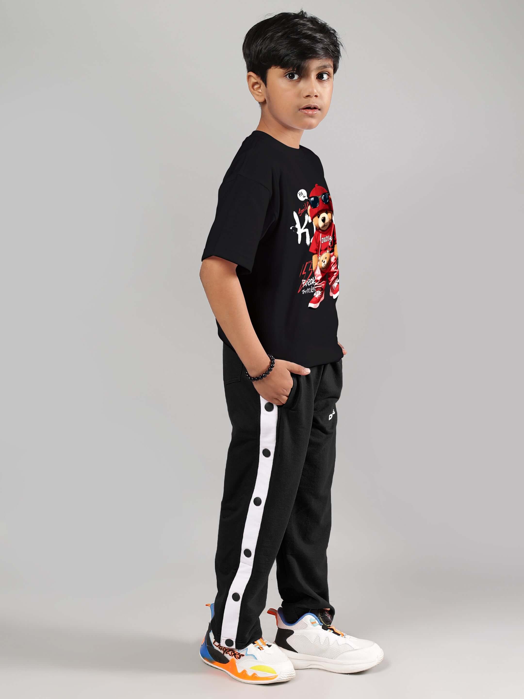 Young boy wearing EZEL JOGGER FOR BOYS & GIRLS BLACK with a casual outfit, showcasing comfort and style.