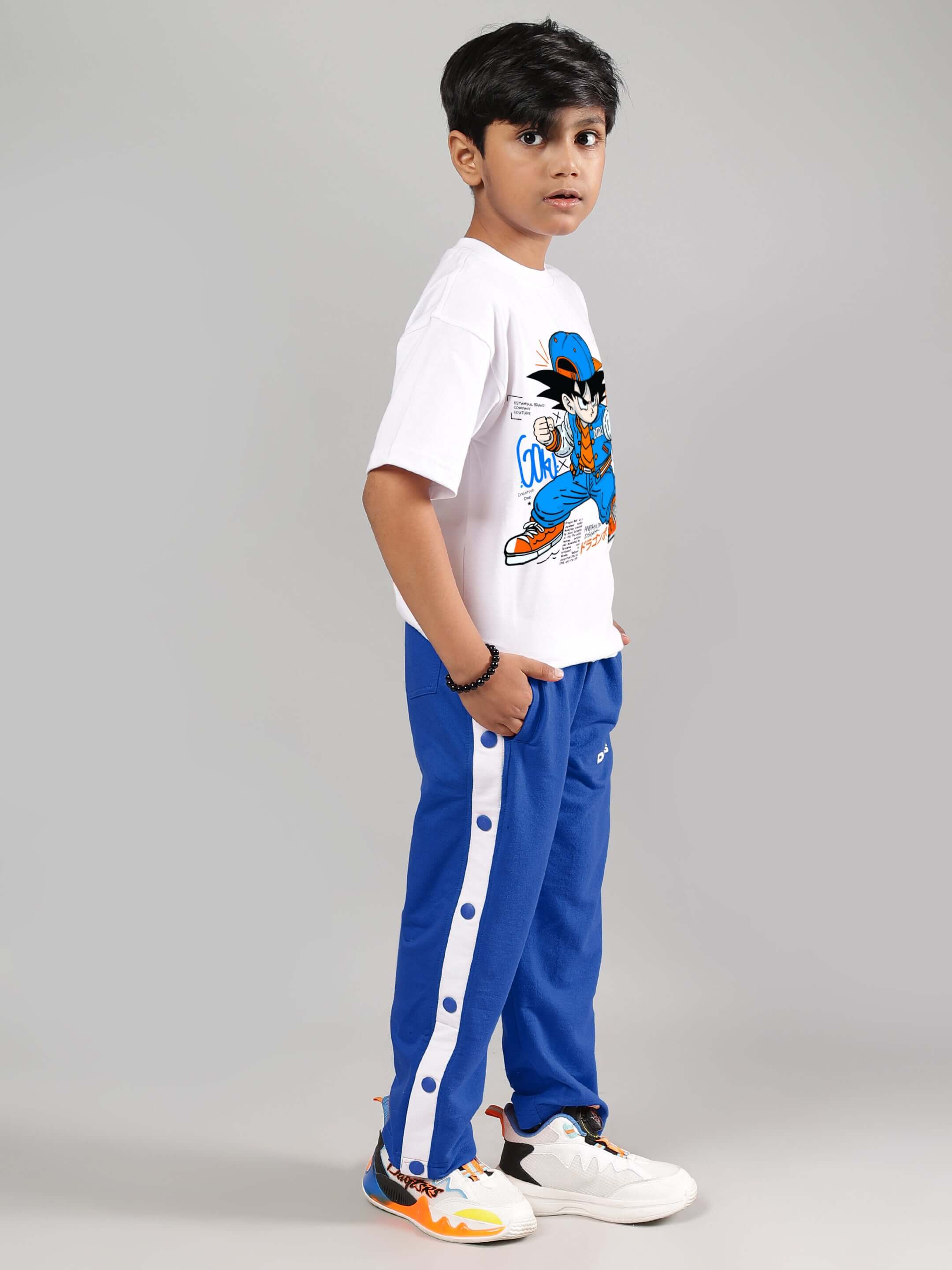 Young boy wearing EZEL JOGGER FOR BOYS & GIRLS BLUE with button details, showcasing custom fit option.