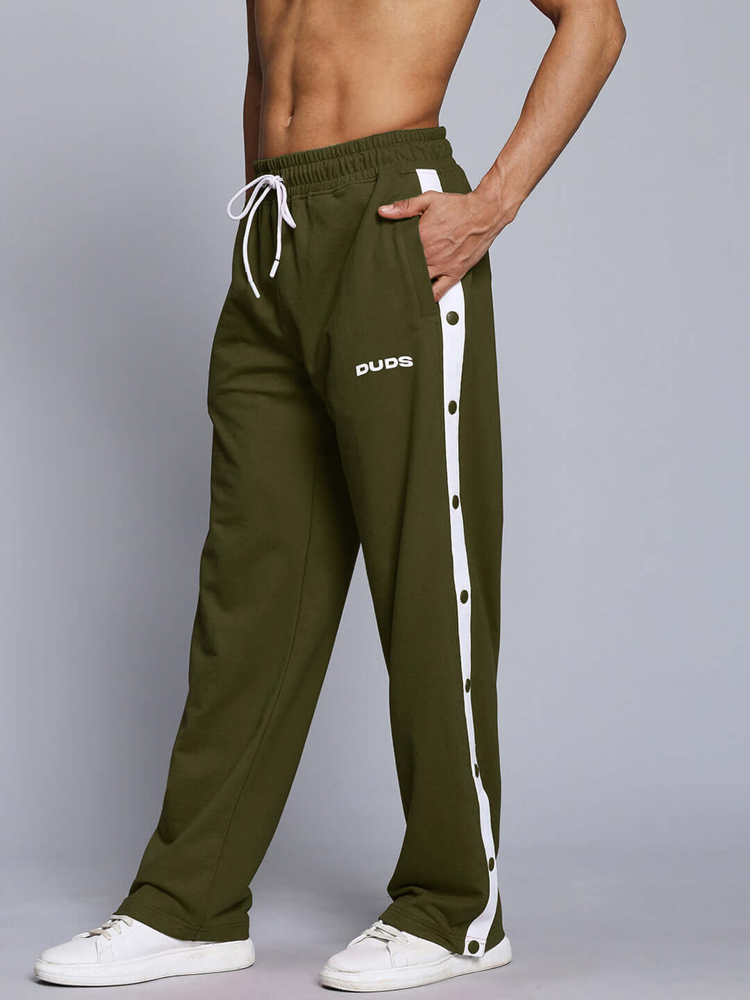 Model wearing olive green EZEL Relaxed Fit Jogger with white stripe, designed by DUDS, featuring comfortable tailored fit.