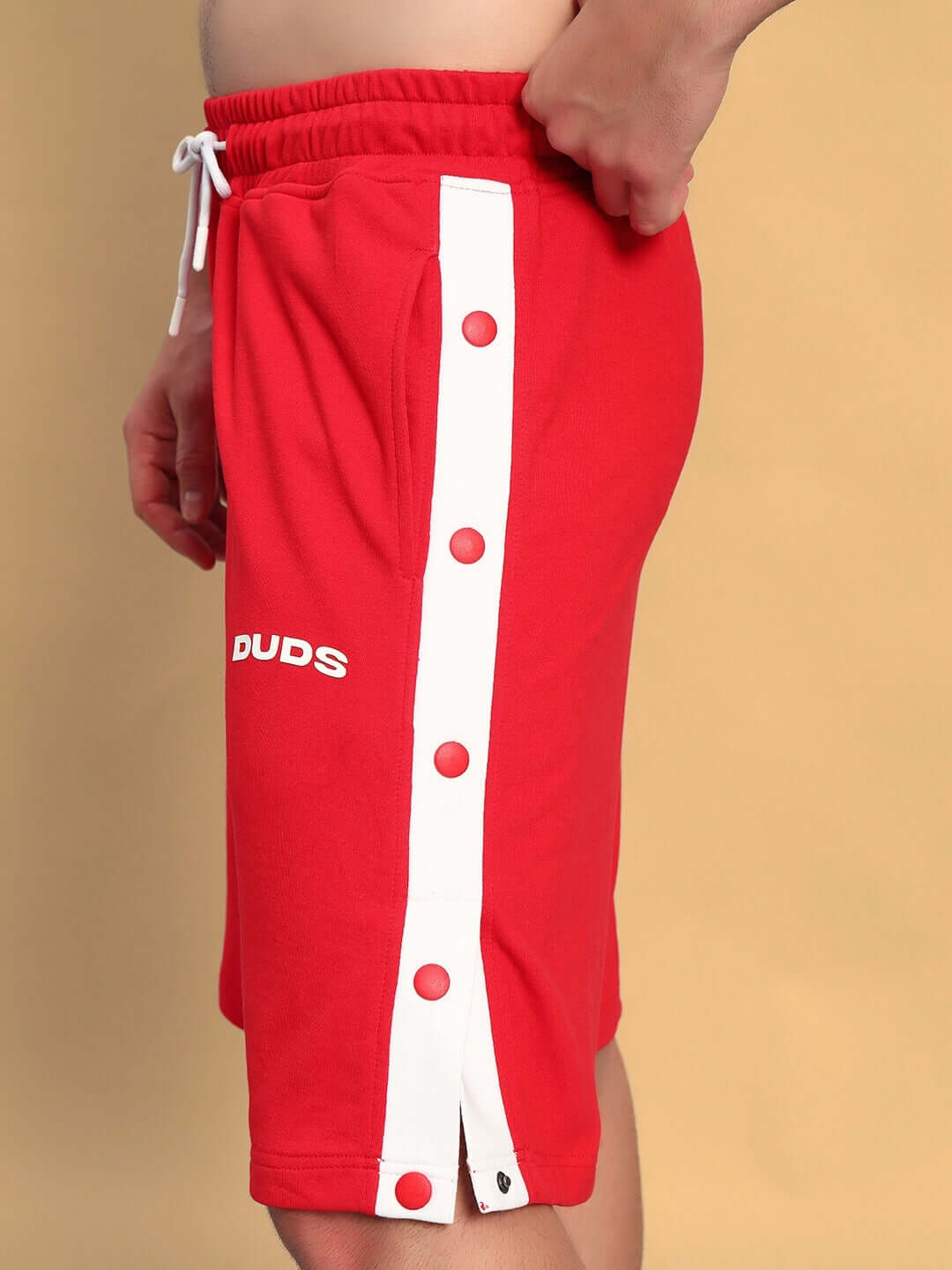 Side view of EZEL REGULAR FIT COTTON SHORTS RED with white button details, perfect for casual styling and comfort.