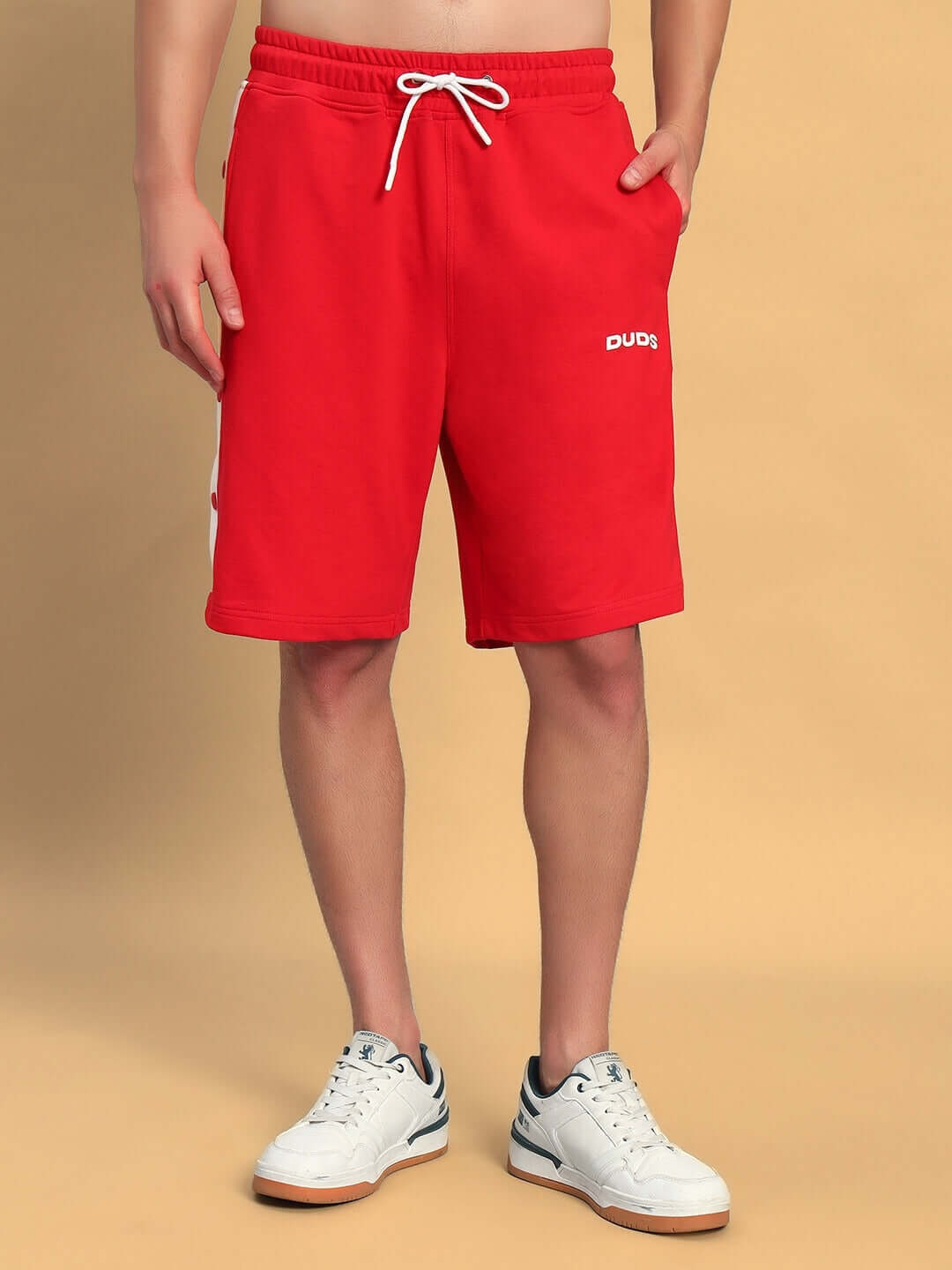 Model wearing EZEL REGULAR FIT COTTON SHORTS RED with sneakers.