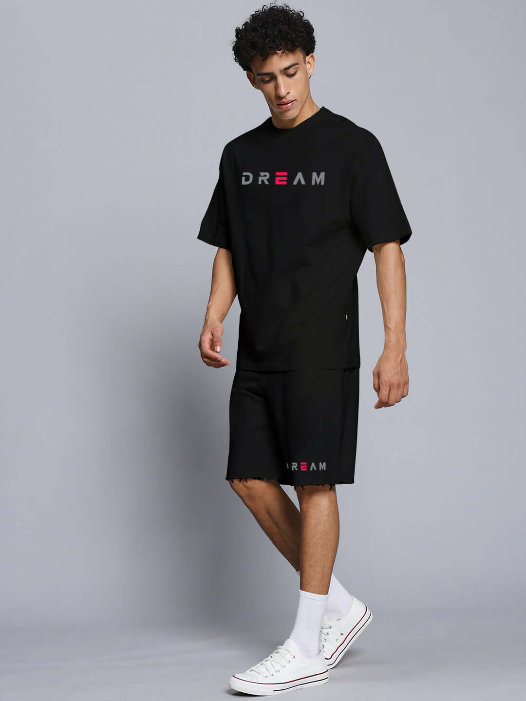 Man wearing black Fancy Dream Co-ord Set made of premium cotton French terry lycra, featuring the word 'DREAM' on shirt and shorts.