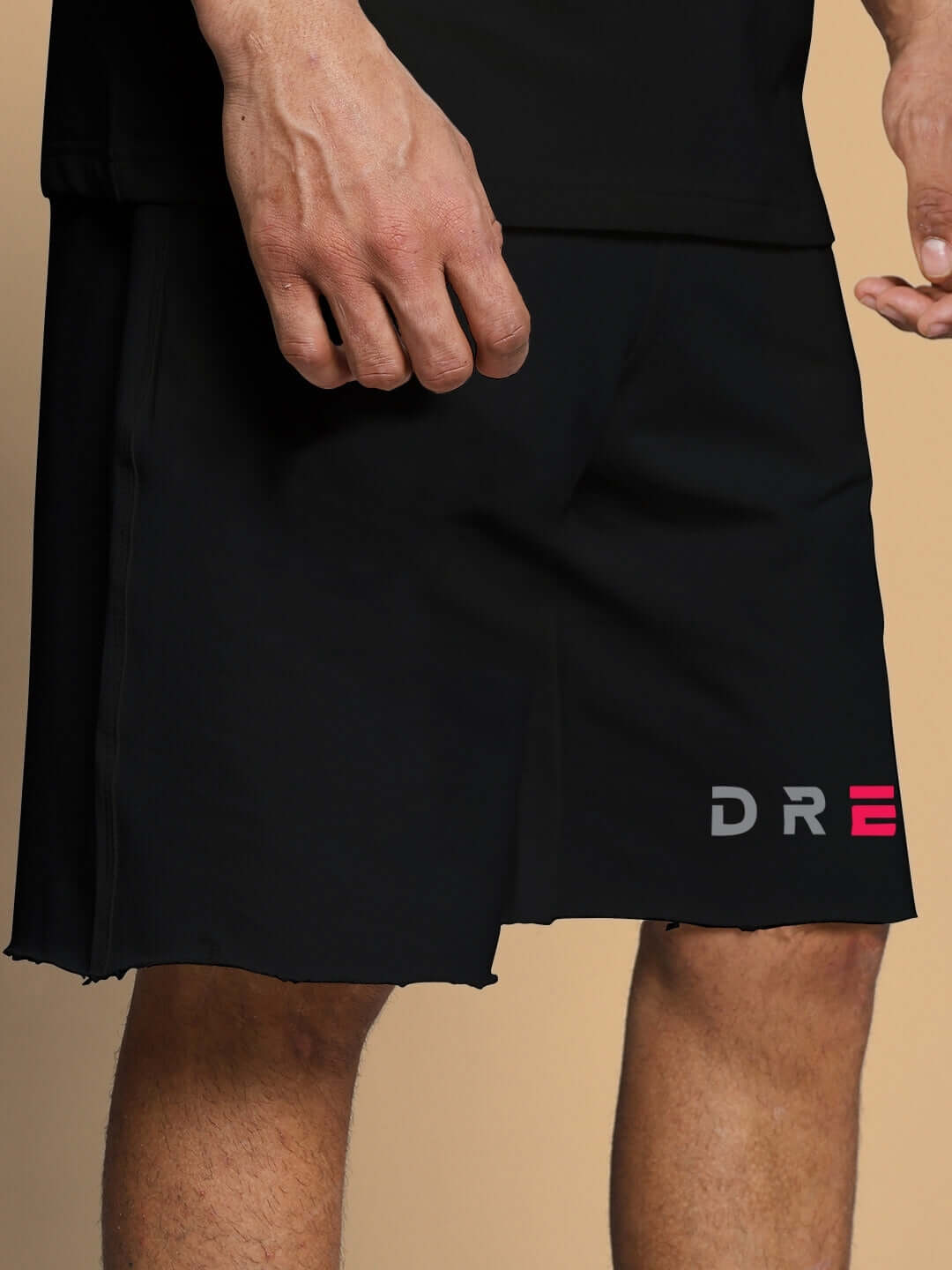 Man wearing FANCY DREAM REGULAR FIT SHORTS BLACK with logo on side, showcasing comfort and style.