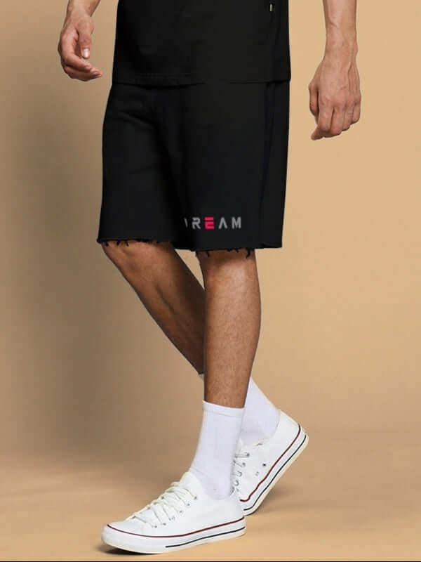 Person wearing Fancy Dream Regular Fit Shorts Black paired with white sneakers for a comfortable look.