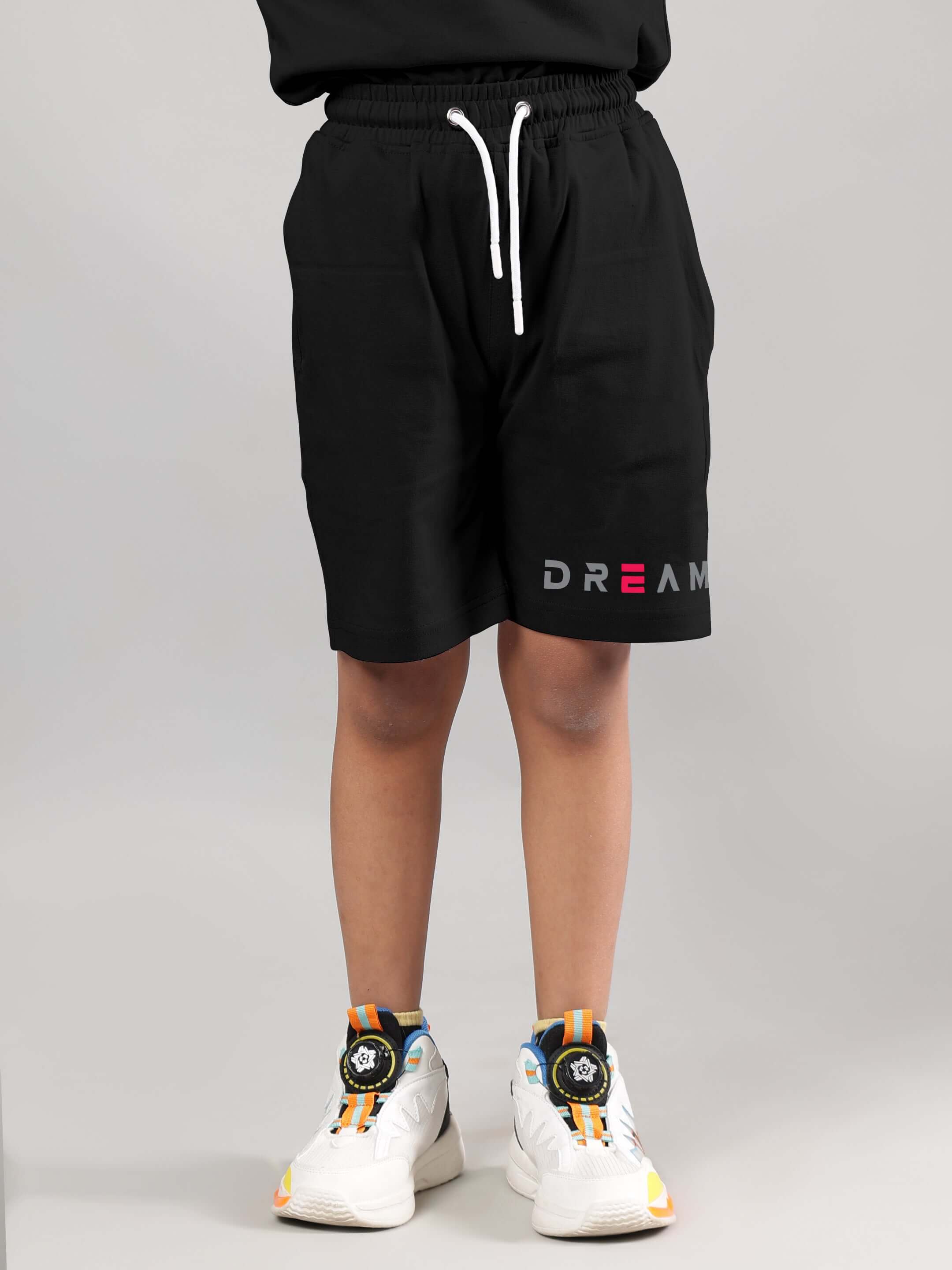 Child wearing black Fancy Dream shorts by DUDS, featuring customizable fit options. Made to order with experienced tailoring.