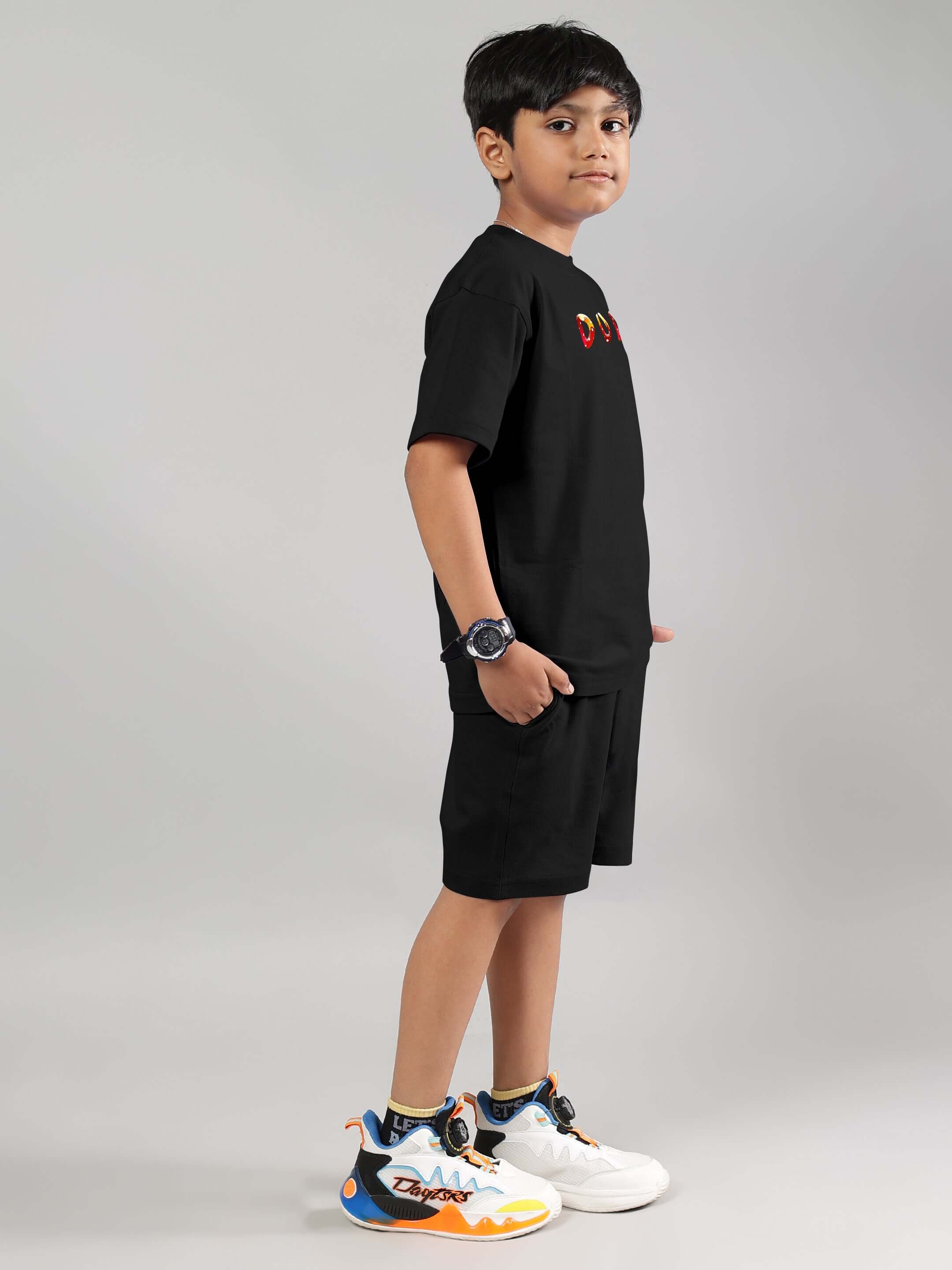 Boy wearing black Fantasy Mushroom co-ord set with colorful sneakers, designed for boys and girls, made by DUDS, customizable fit option available.
