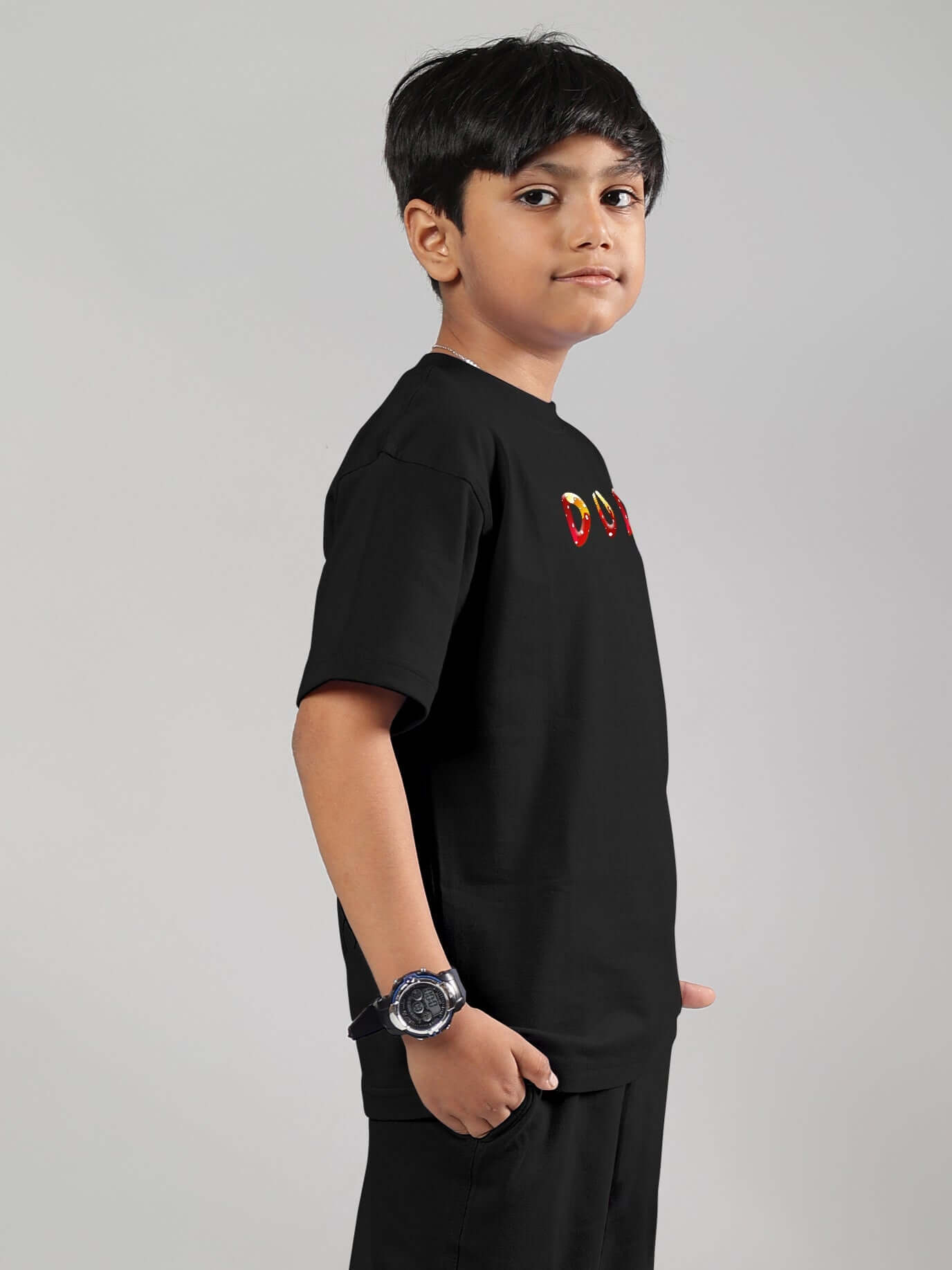 Young boy modeling black fantasy mushroom t-shirt for kids. Custom fit and made-to-order options available. Shipping 7-10 days.