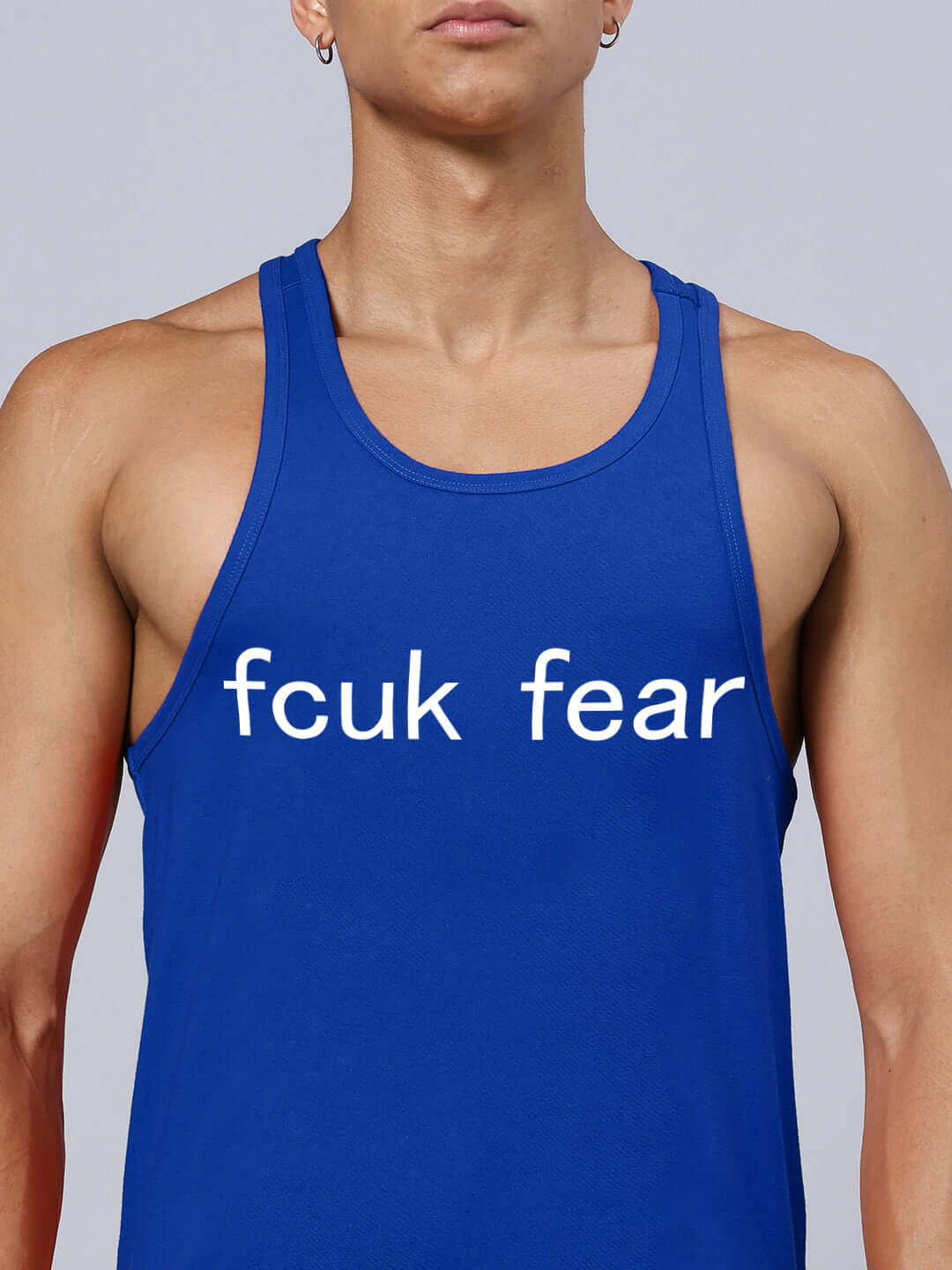 Blue athletic tank top with bold text "fcuk fear" printed on the front.