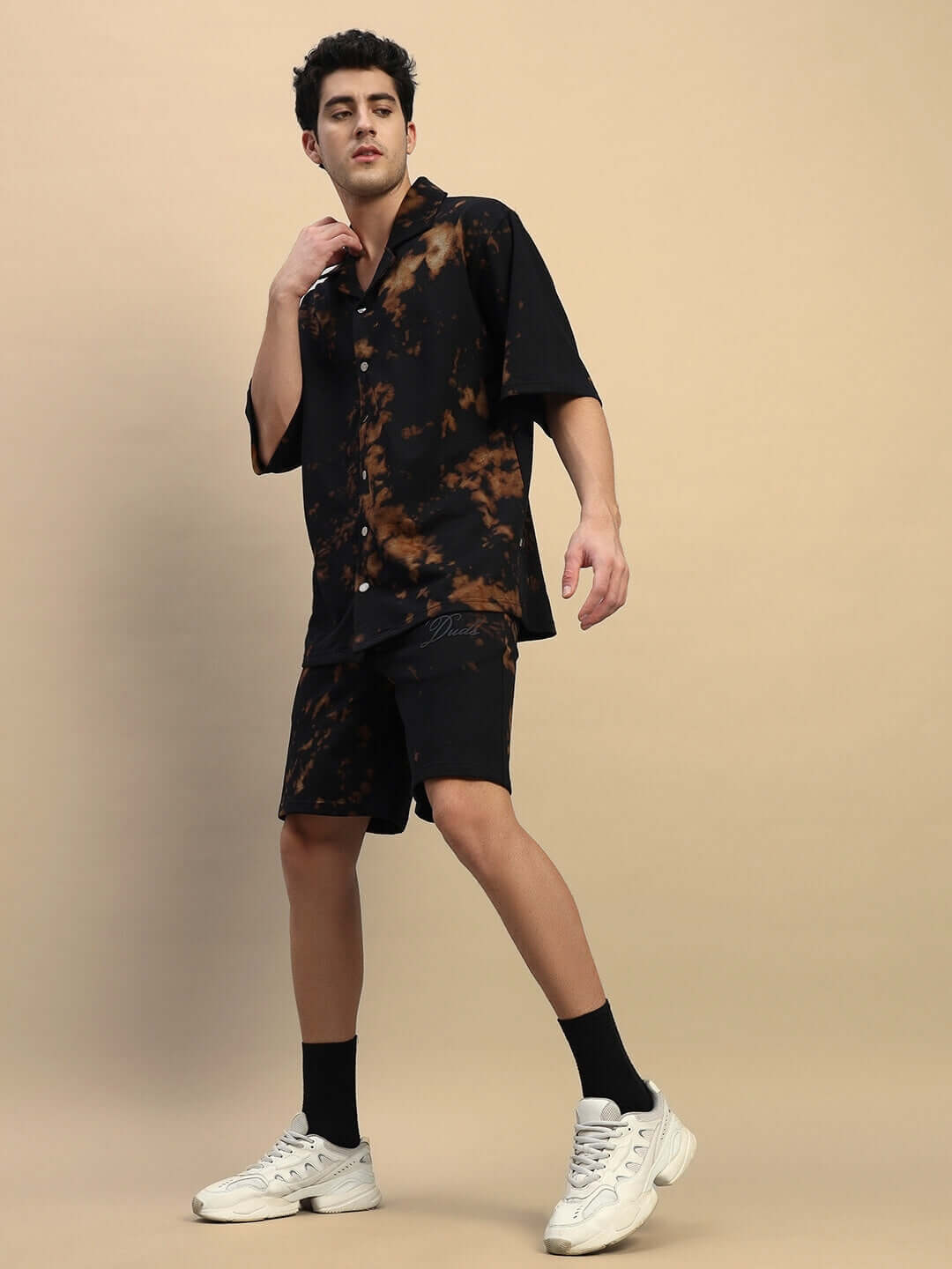 Model wearing a black tie-dye co-ord set made from premium cotton blend, featuring a casual fit and modern design perfect for comfortable fashion.