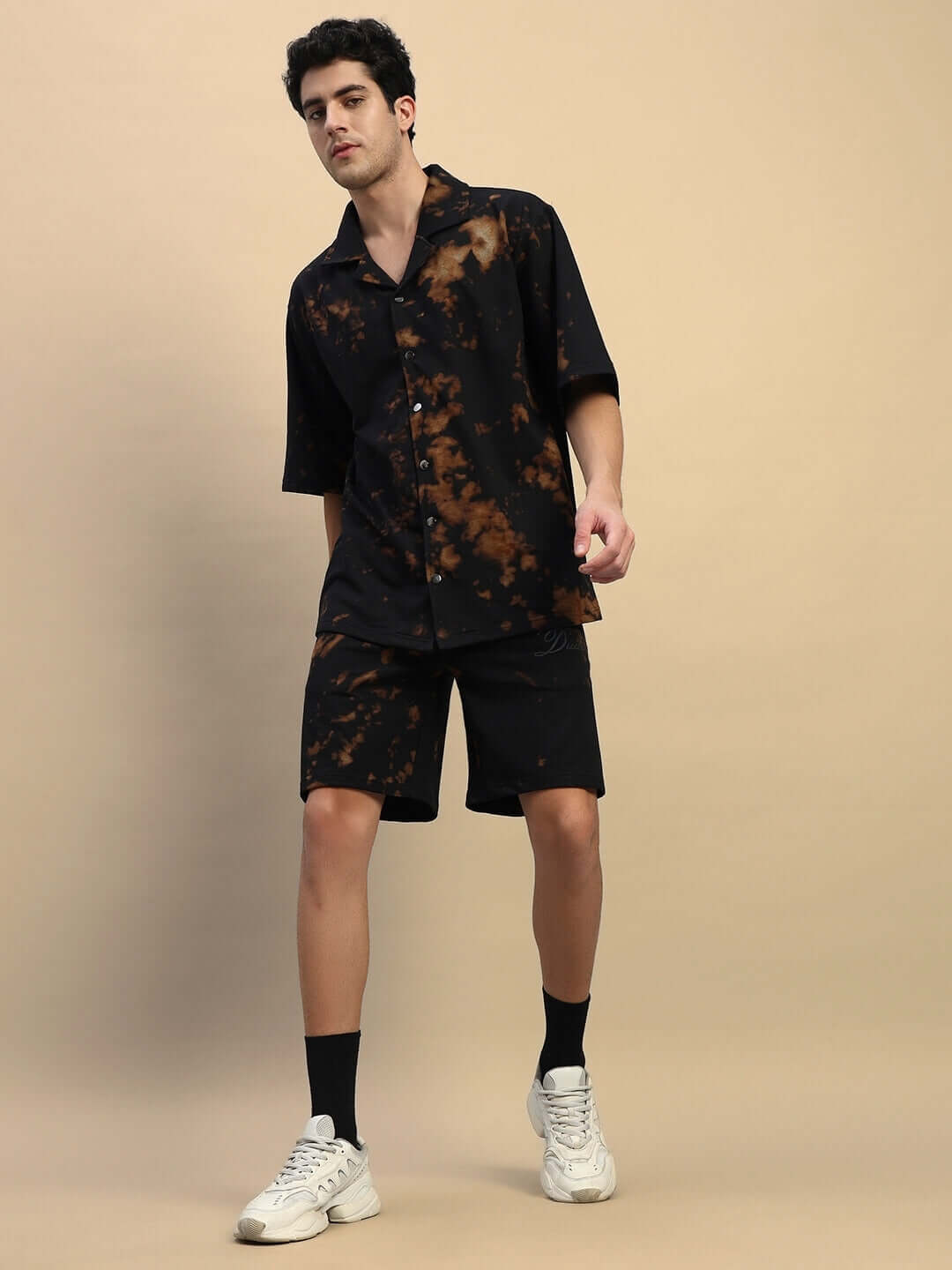 Black tie-dye co-ord set featuring premium cotton fabric, modeled with sneakers. Perfect for a stylish, relaxed look.