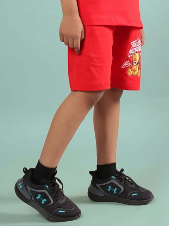 Child wearing FEELS NOTHING SHORTS FOR BOYS & GIRLS RED with teddy bear design, suitable for casual wear.
