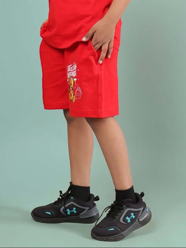 Child wearing FEELS NOTHING SHORTS FOR BOYS & GIRLS RED, showcasing a vibrant design and comfortable fit.
