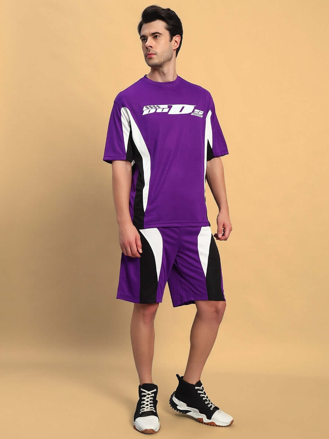 Person wearing FIFA COLORBLOCK CO-ORD SET PURPLE with dynamic purple t-shirt and shorts.