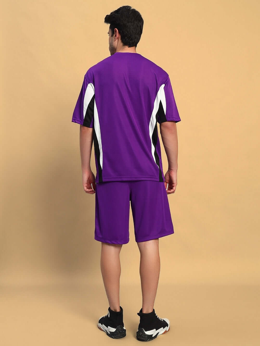 Person wearing FIFA COLORBLOCK CO-ORD SET PURPLE showcasing the dynamic purple athletic design.