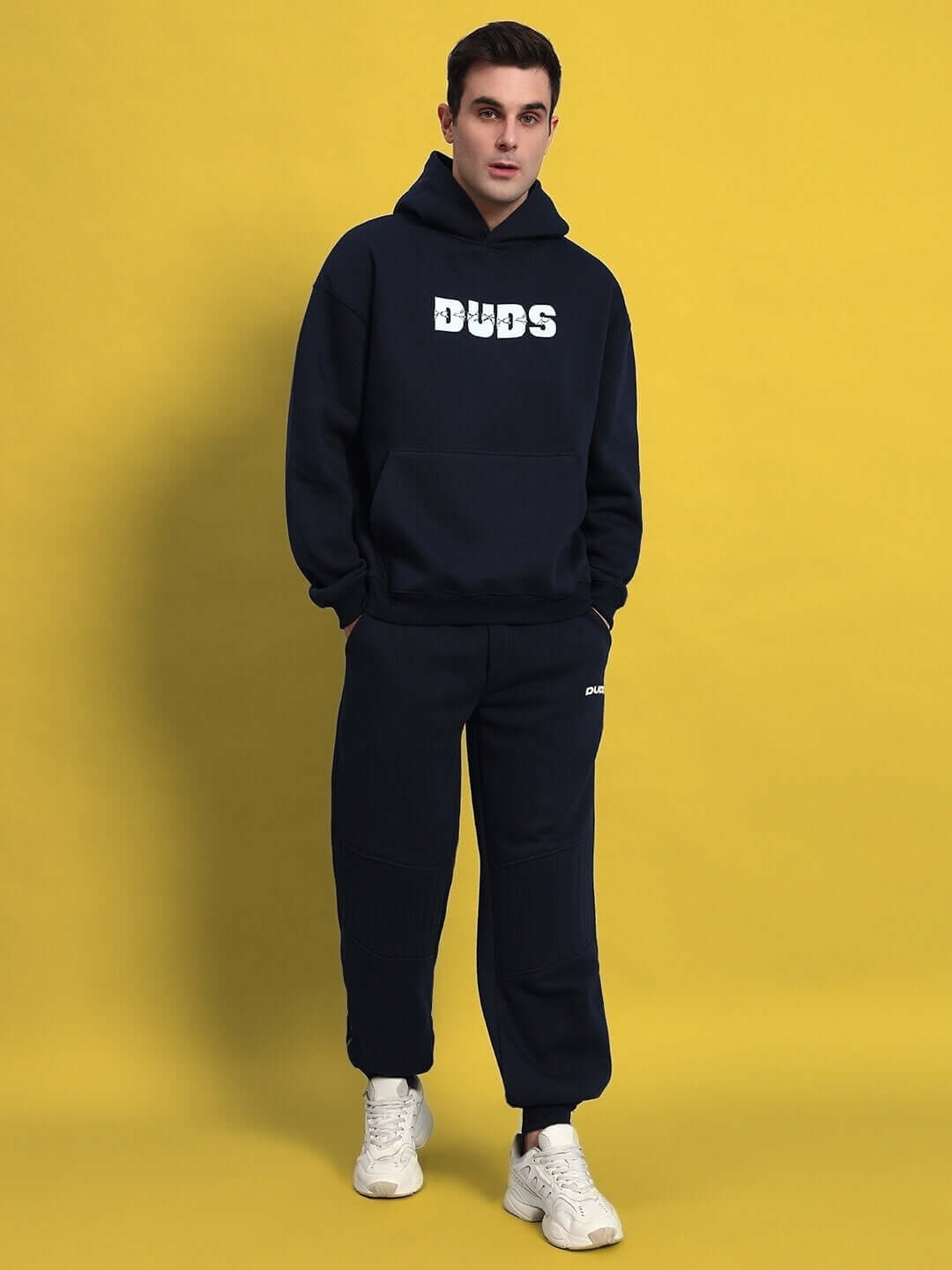 Model wearing Fight Night Fleece Co-Ord Navy Blue, a unisex stylish and comfortable outfit perfect for cooler days and street style.