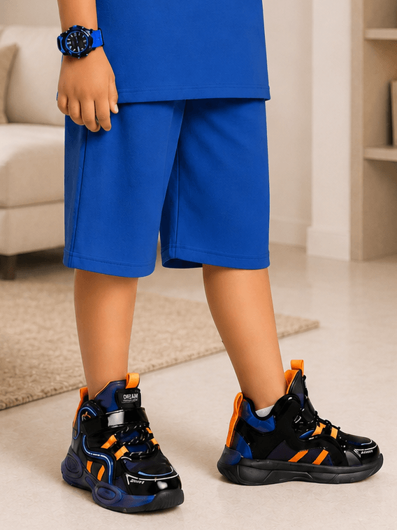 NEON RUSH SHORTS FOR BOYS GIRLS BLUE paired with stylish sneakers for a sporty look.