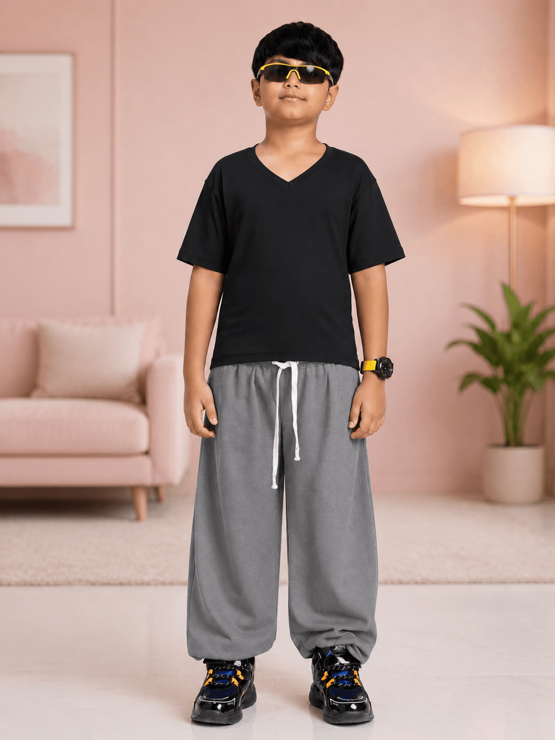 COOLFIT T-SHIRT FOR BOYS GIRLS BLACK worn by a boy with black V-neck t-shirt, gray pants, and stylish sunglasses.