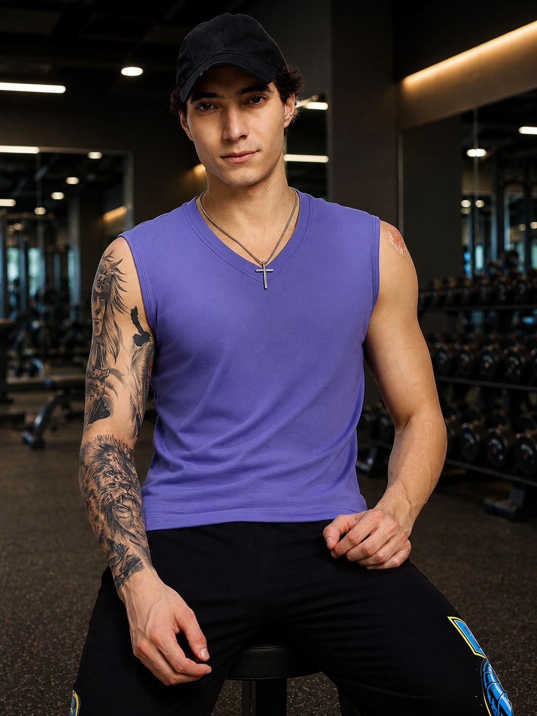 LEVELUP GAMER SLEEVELESS T-SHIRT PURPLE worn by a man in a gym setting, showcasing gaming-inspired style.