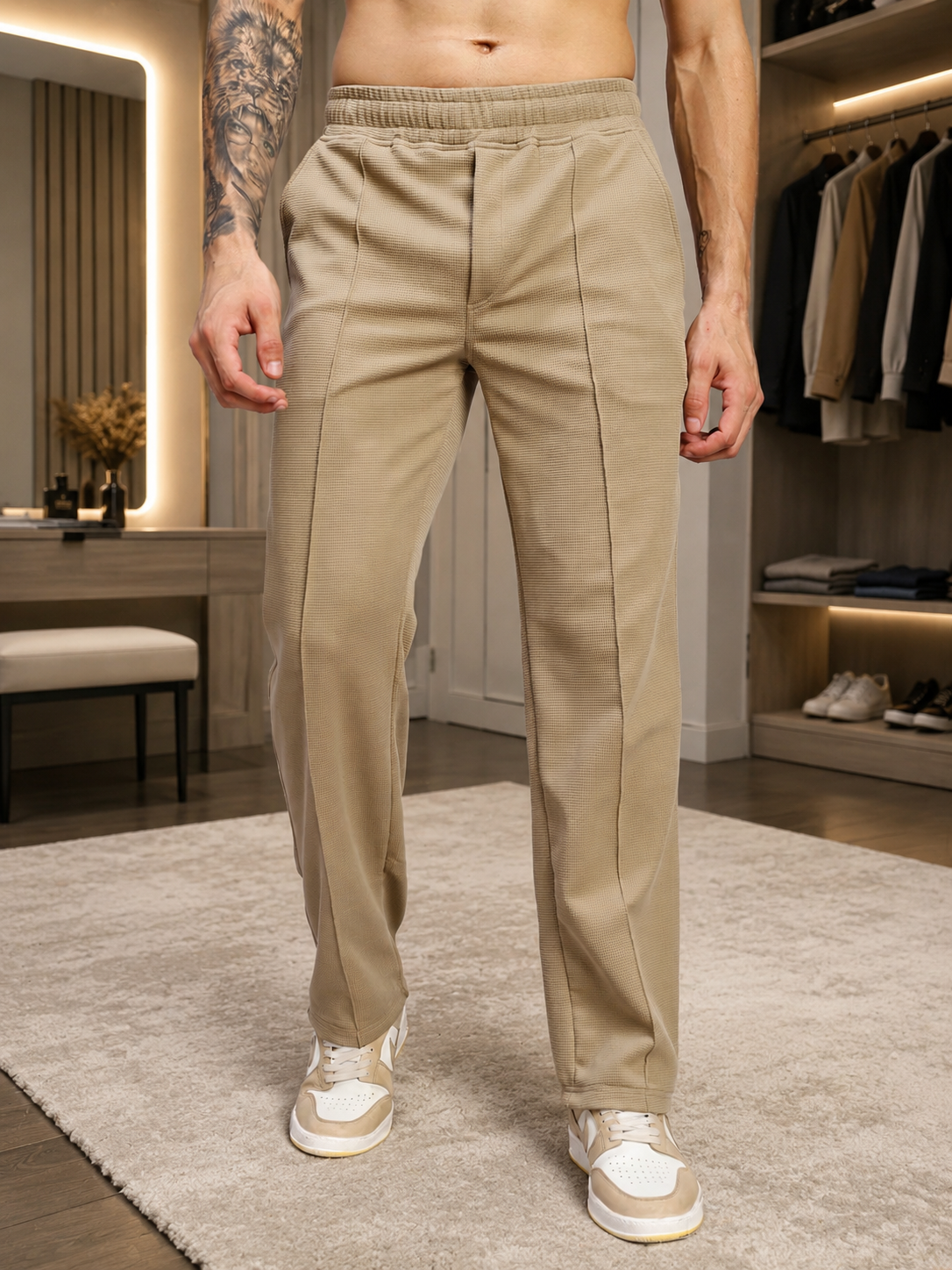 ELITE TEXTURED FIT JOGGERS BEIGE displayed on a model in a stylish setting, showcasing their modern design and tailored fit.