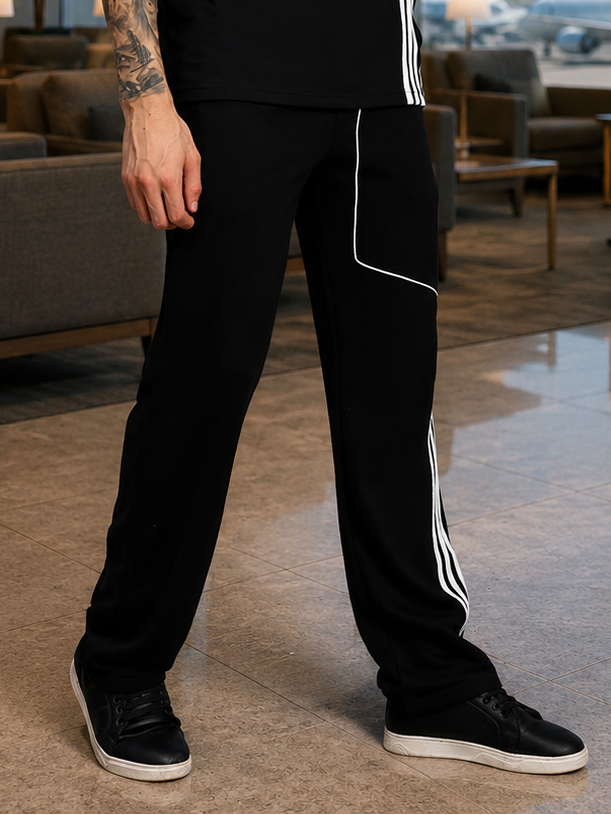 YOUTH CONTREST PIPING JOGGERS BLACK displayed on a model, showcasing stylish design and comfortable fit.