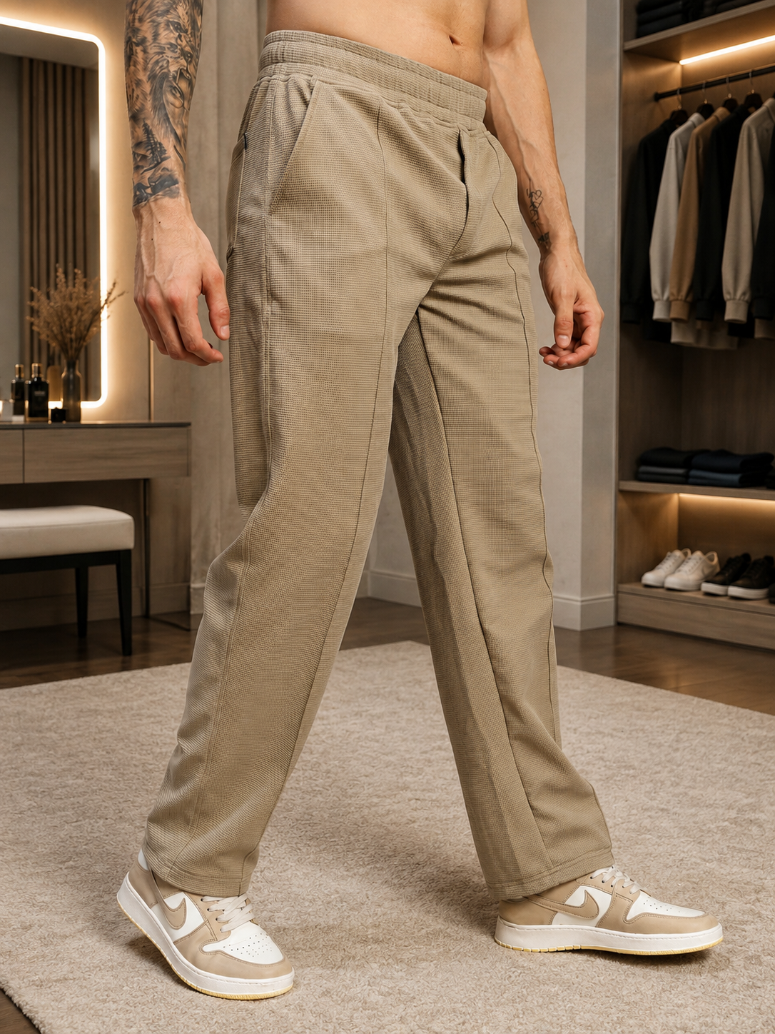Man wearing ELITE TEXTURED FIT JOGGERS BEIGE in a modern setting, showcasing comfort and style.